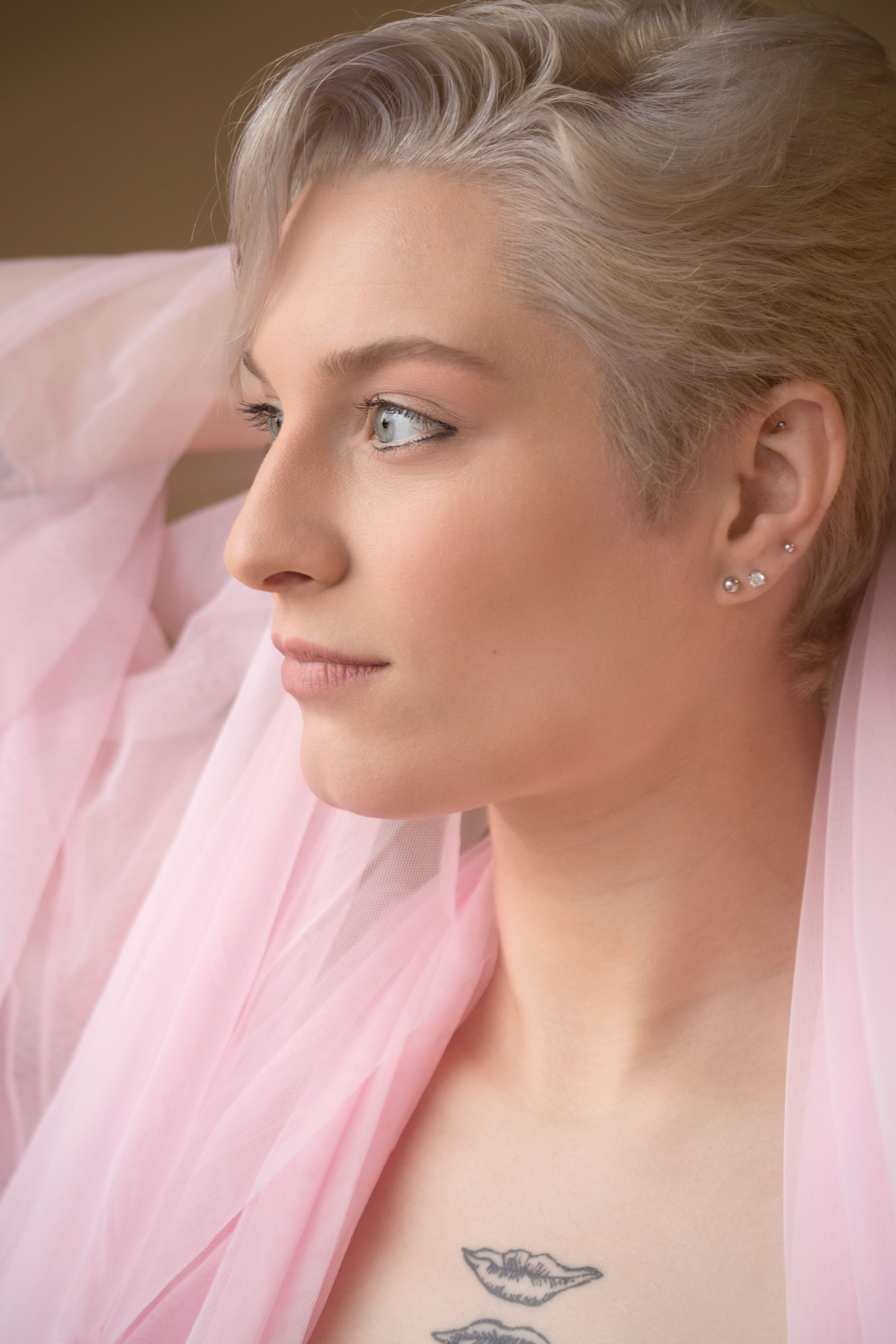 Head and shoulders of beautiful young woman in window light.