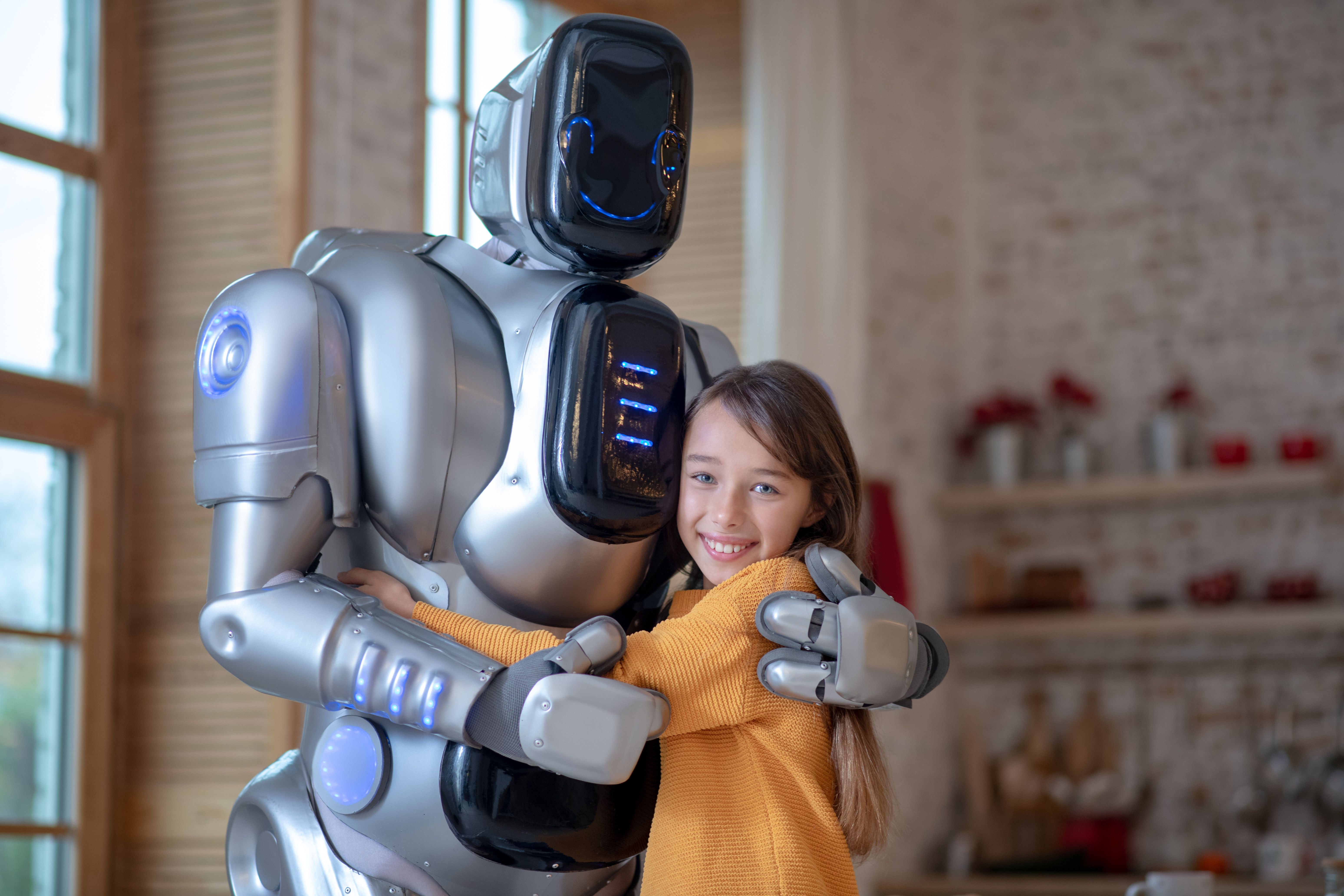 Picture of cute girl and big robot in the kitchen Picture of cute girl and big robot in the kitchen