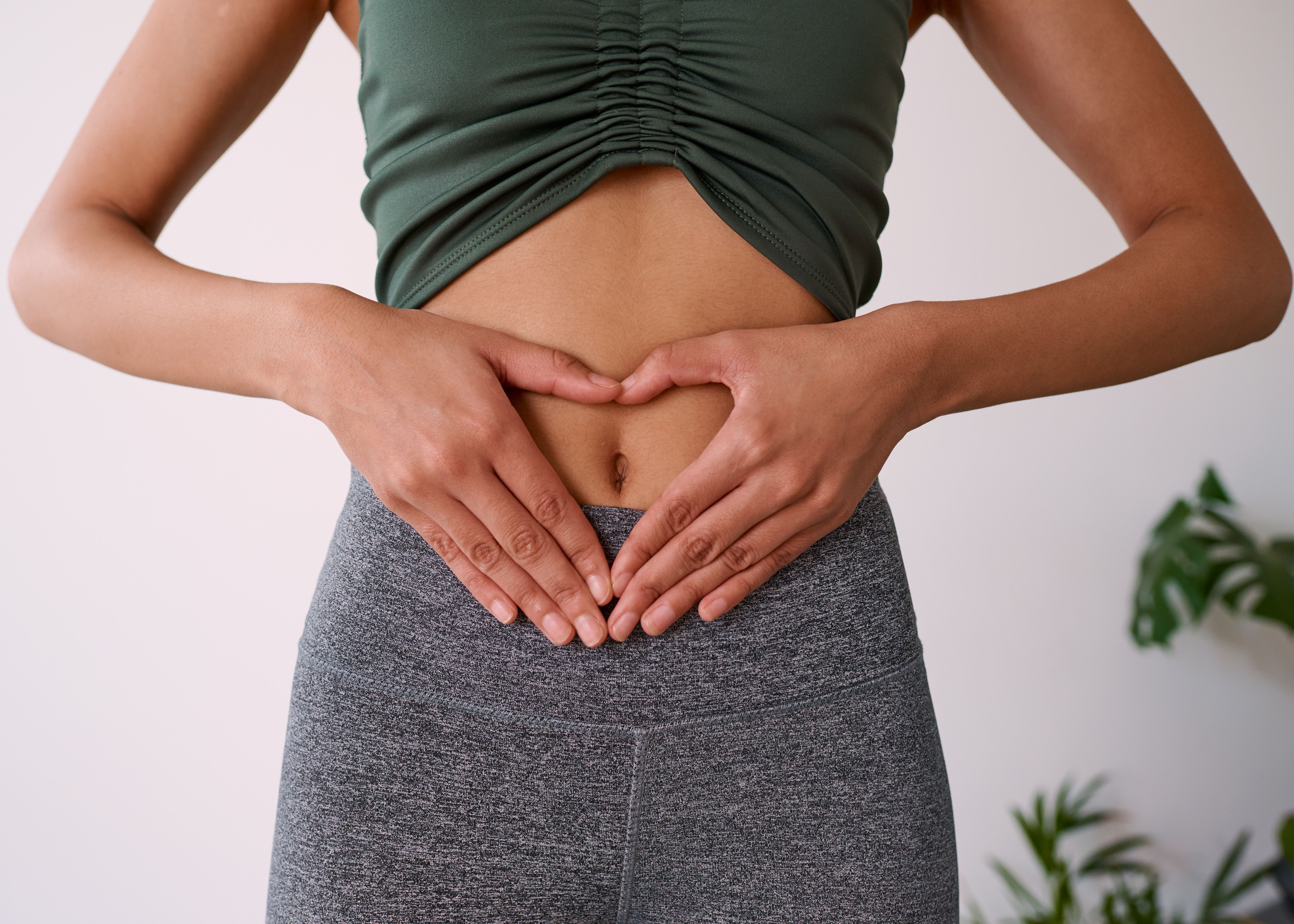 Close up of a multi-ethnic woman's hands on her stomach