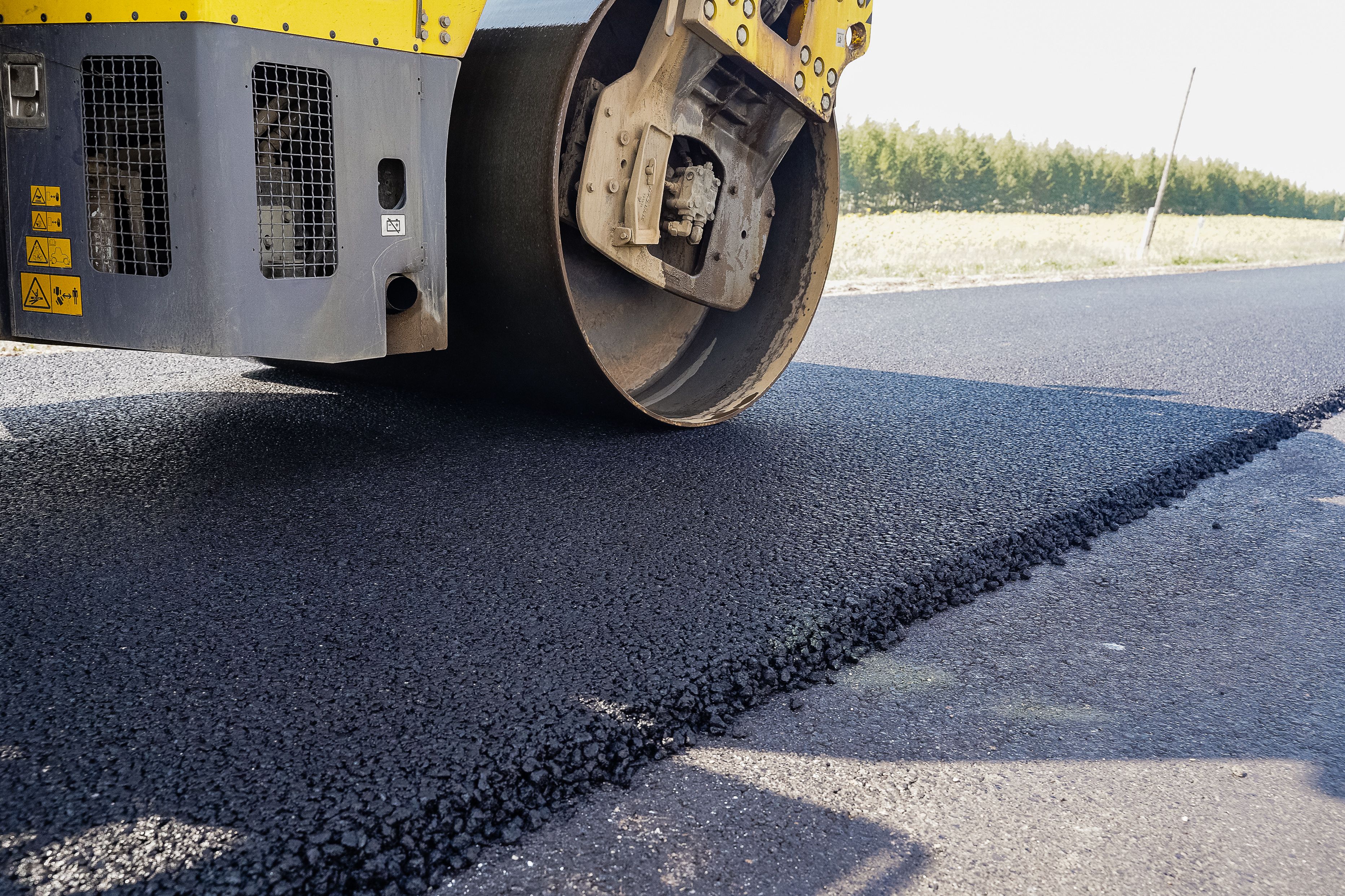 road equipment lays asphalt, road works, paver, road repairs