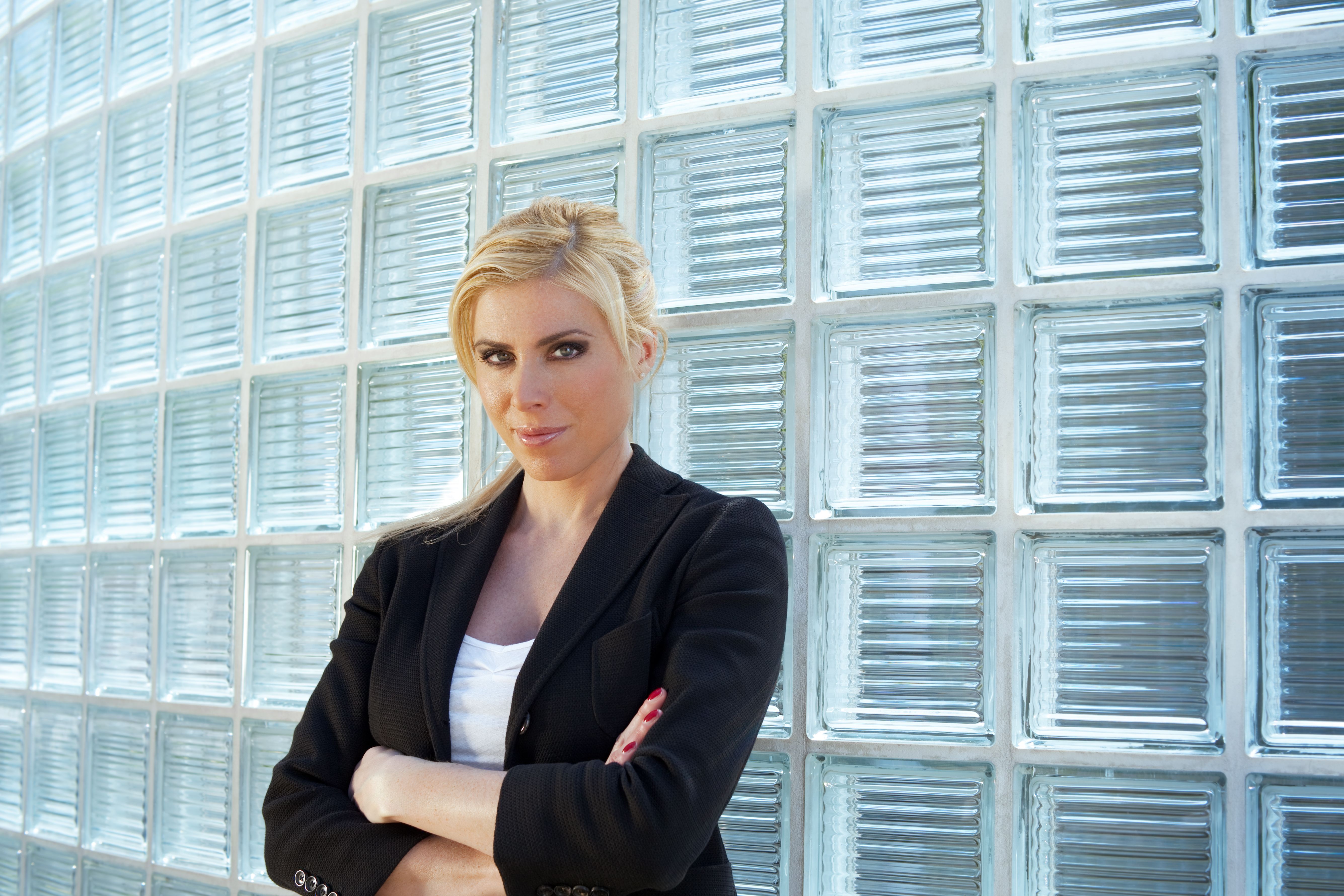 business woman leaning on glass bricks business woman leaning on glass bricks