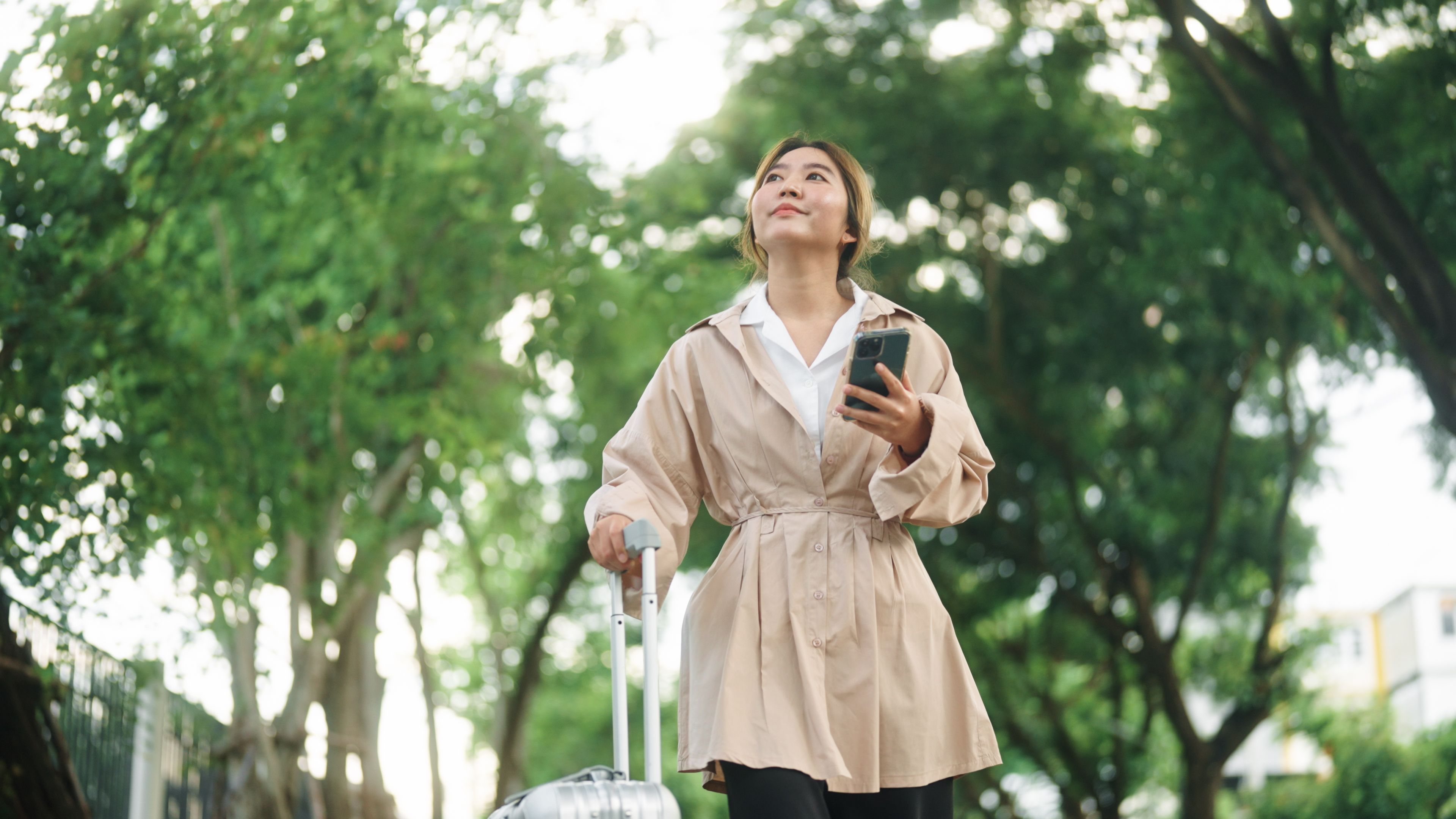 Businesswoman using smartphone while travelling to her Airbnb