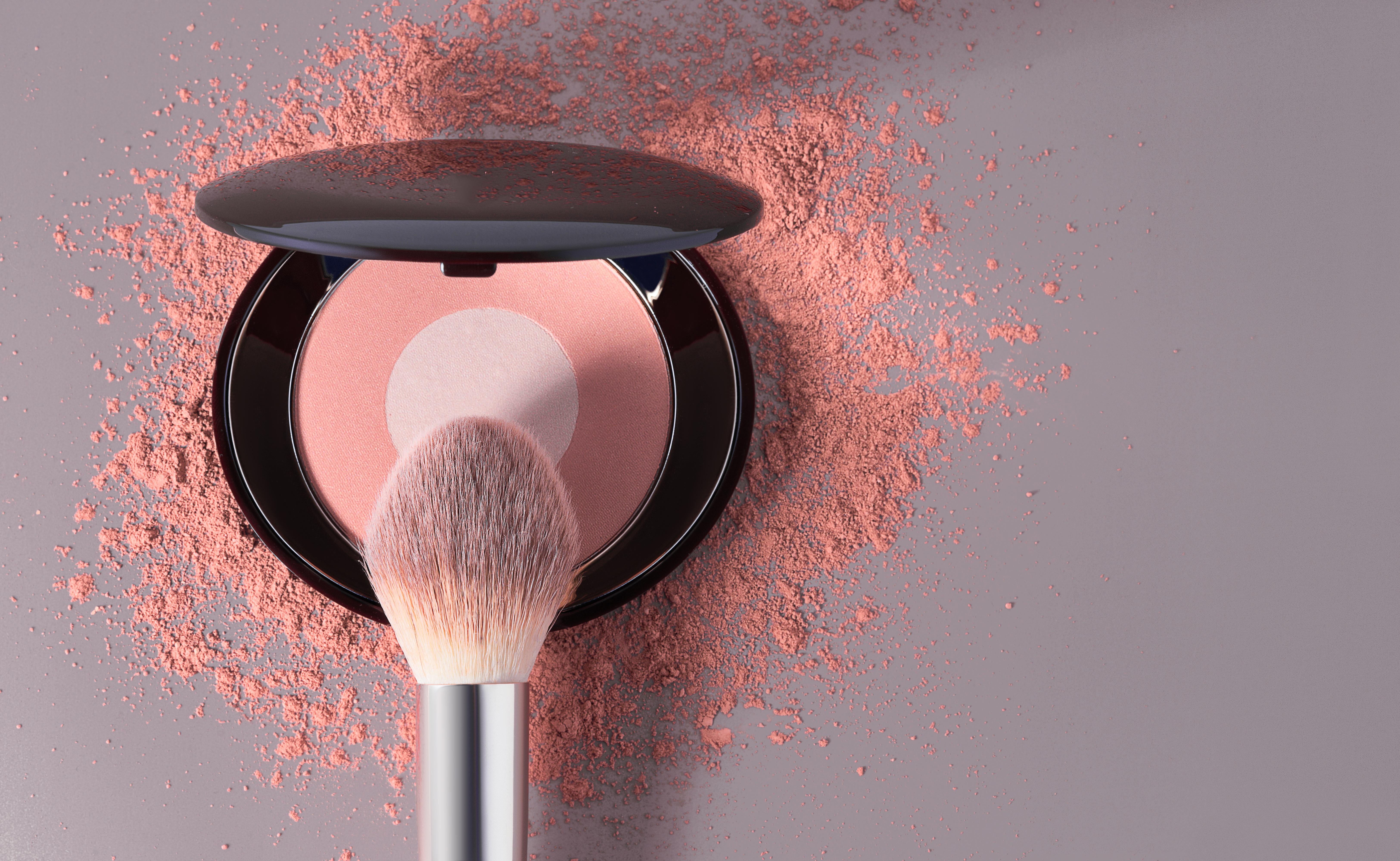 Round pink blusher and crashed eyeshadow for make up. with space for text. Sample of cosmetic product