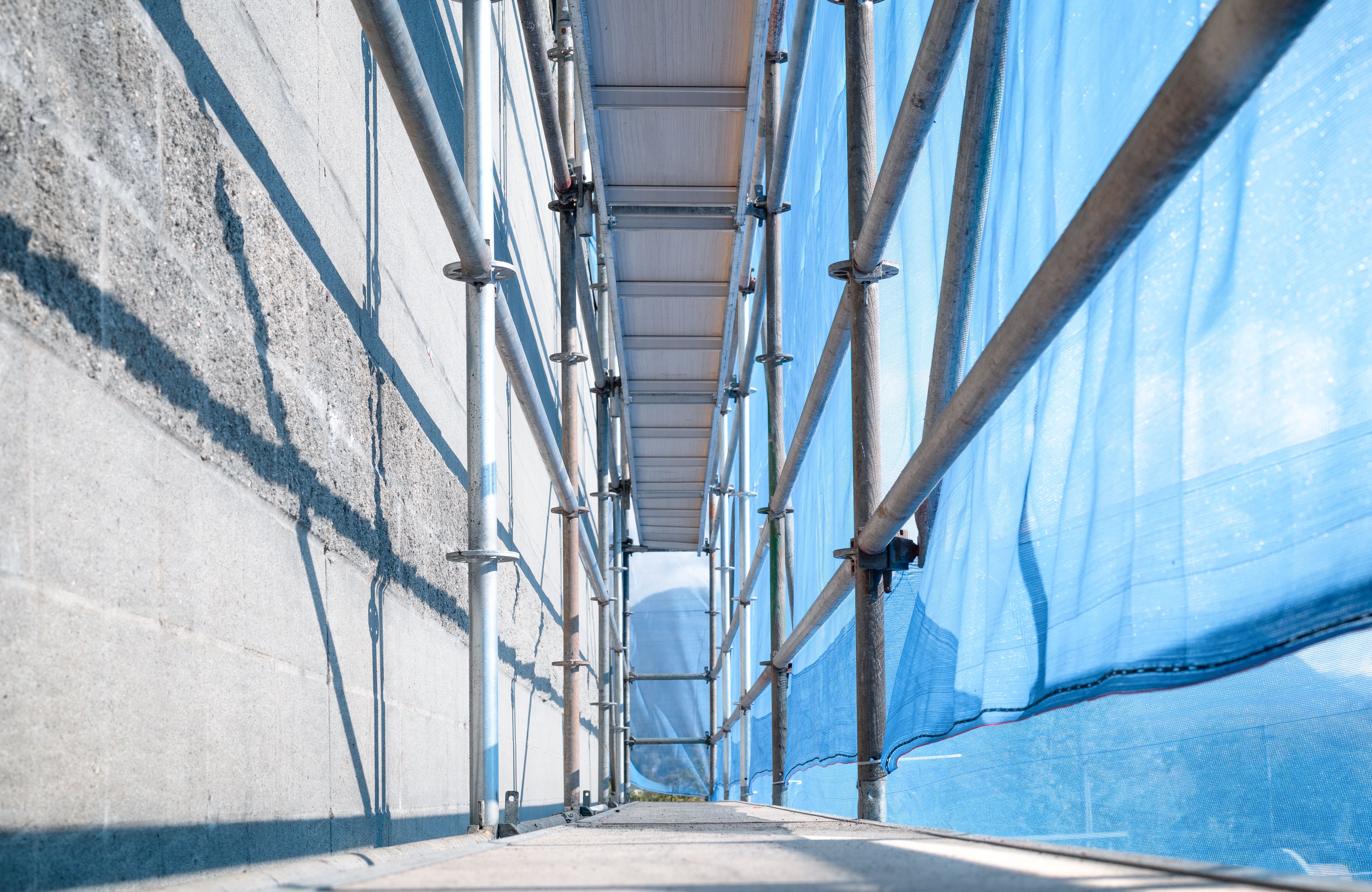 Scaffolding with scaffold netting. Scaffolding with scaffold netting.