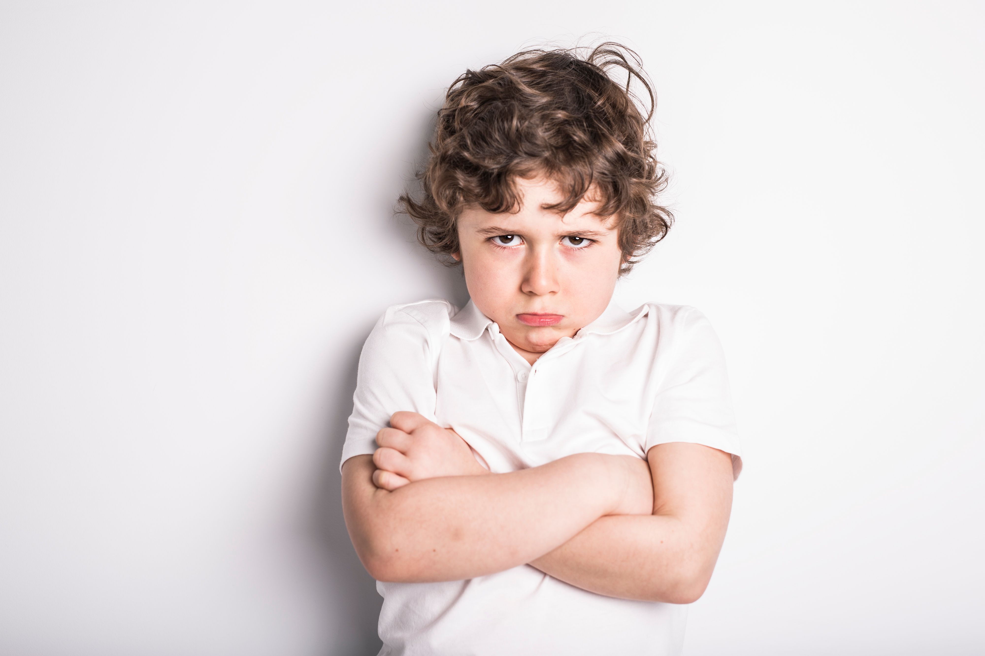 Head and Shoulders Close Up Portrait of Young boy with Sulk attitude