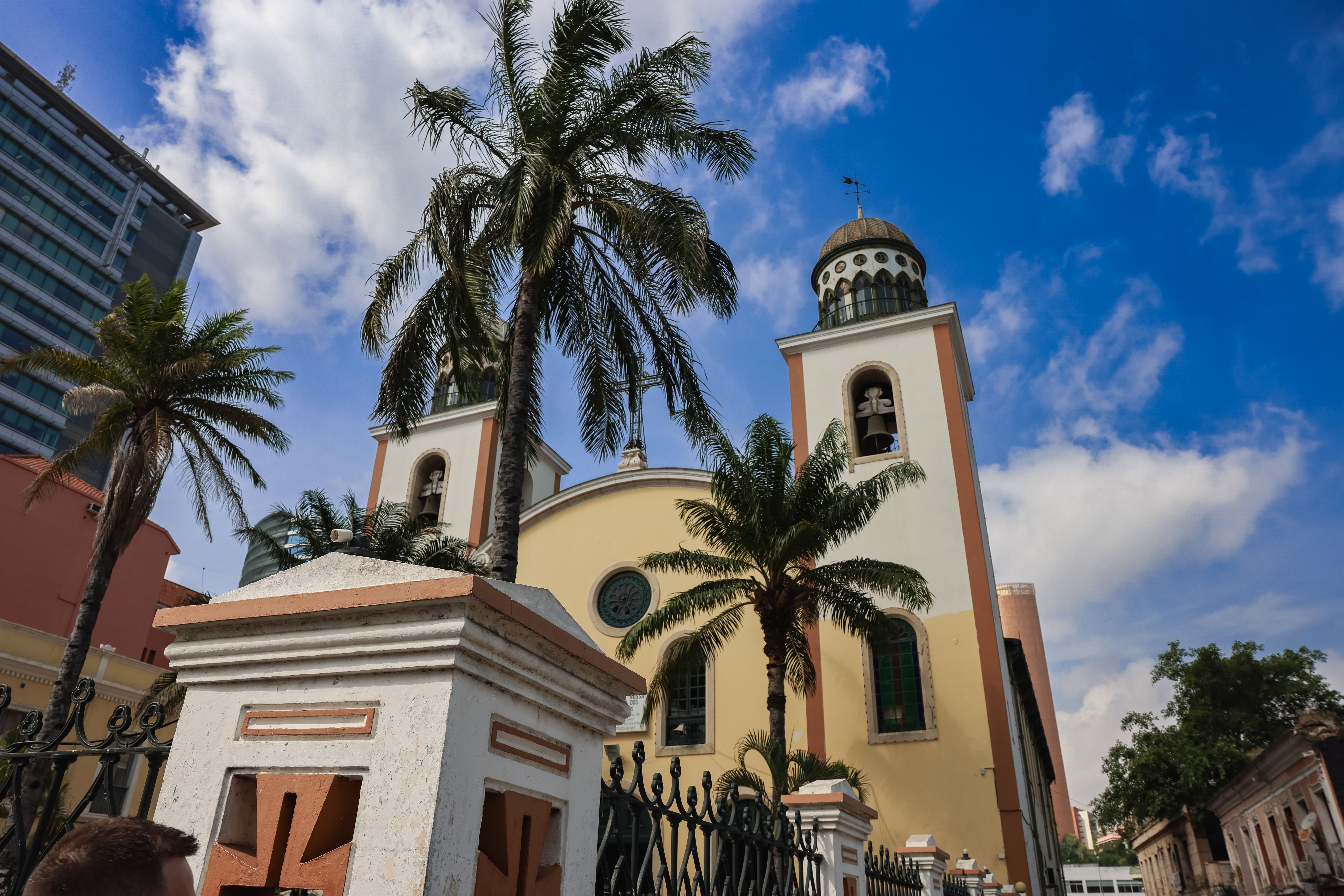 Historic church in Luanda Angola surrounded by palm trees under a bright sky Historic church in Luanda Angola surrounded by palm trees under a bright sky