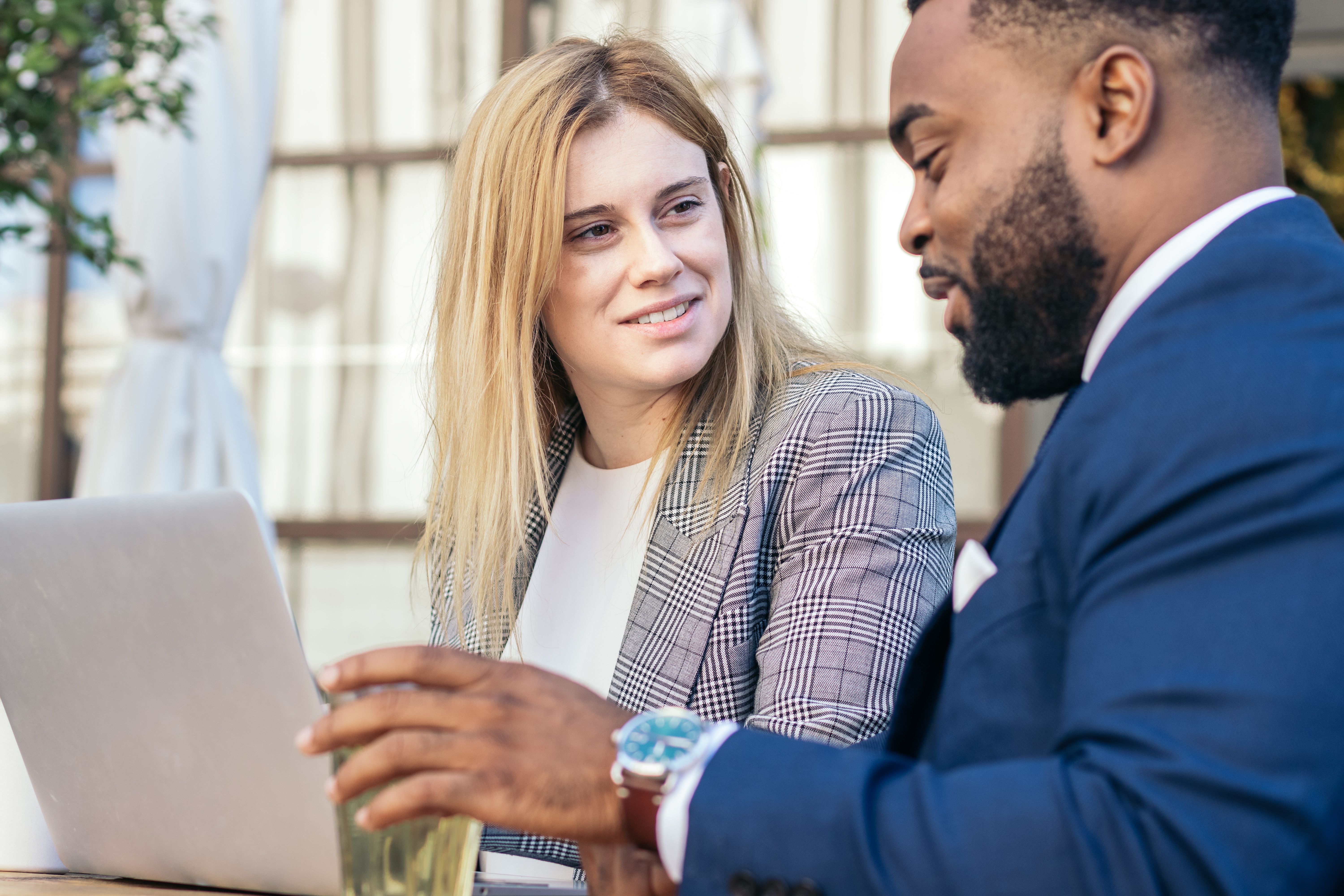 Business man and woman in a meeting in an outdoor cafe