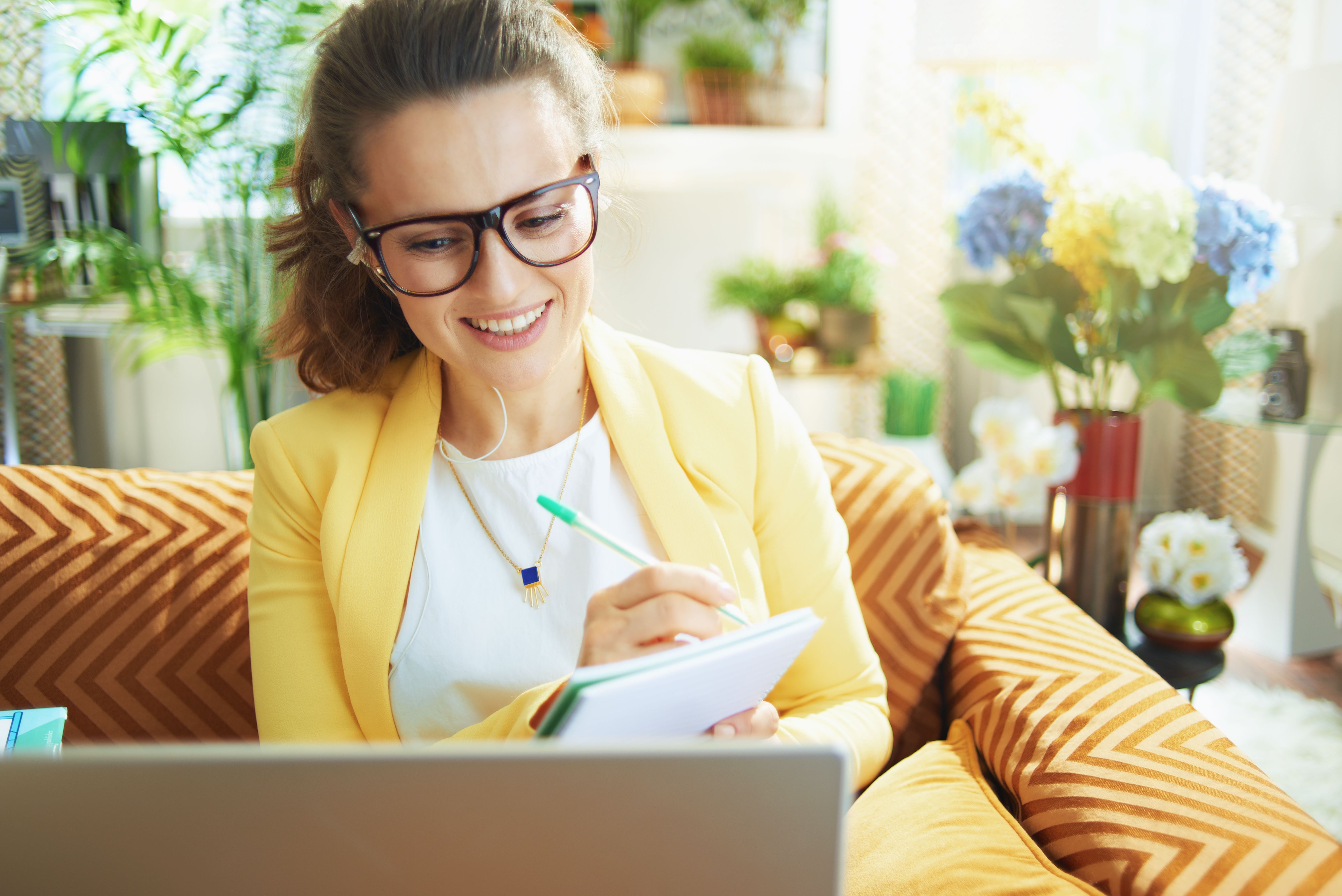 learner woman at modern home in sunny day watching web lecture