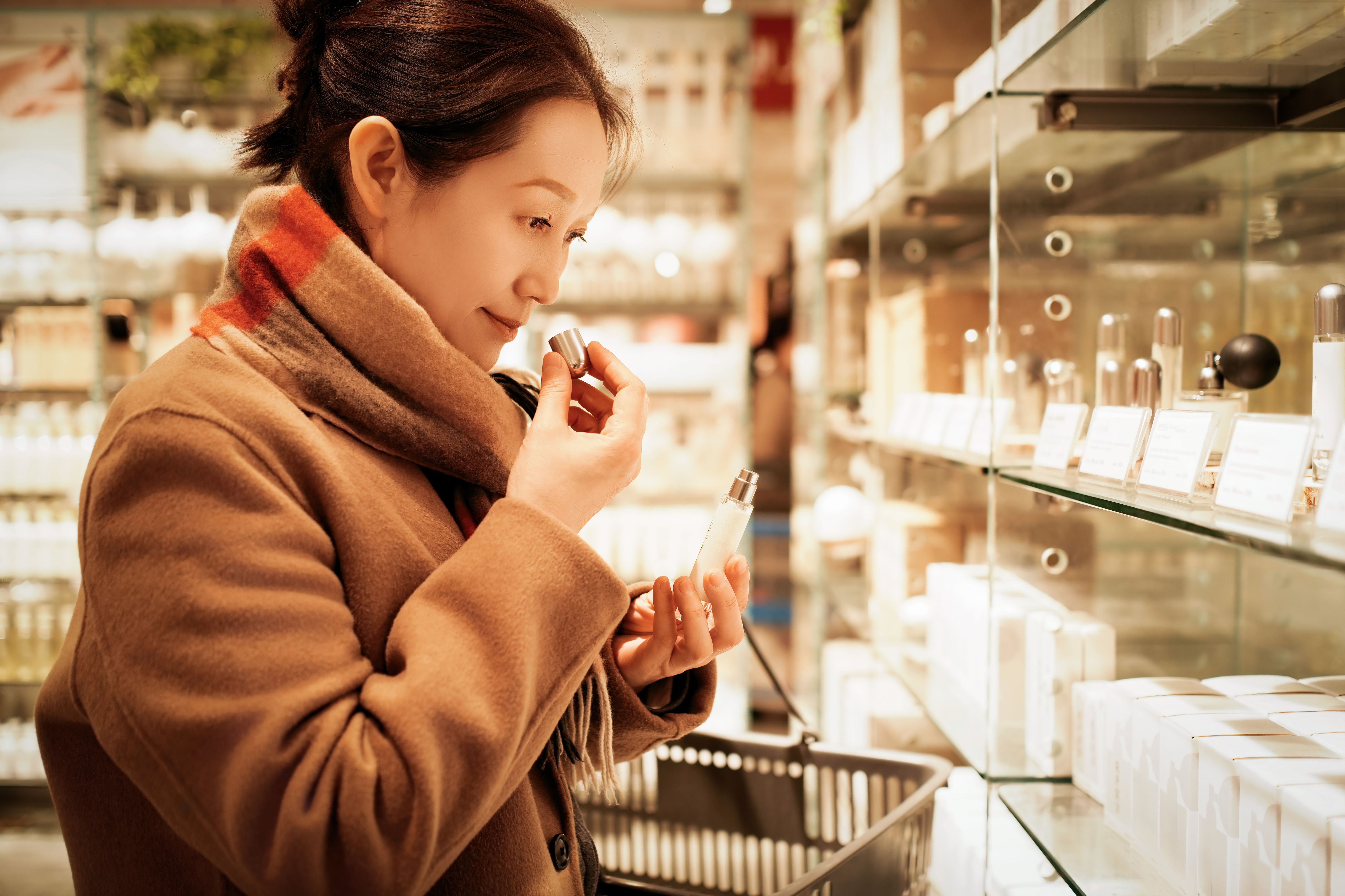 Woman Shopping for Perfume in Cosmetics Store Woman Shopping for Perfume in Cosmetics Store