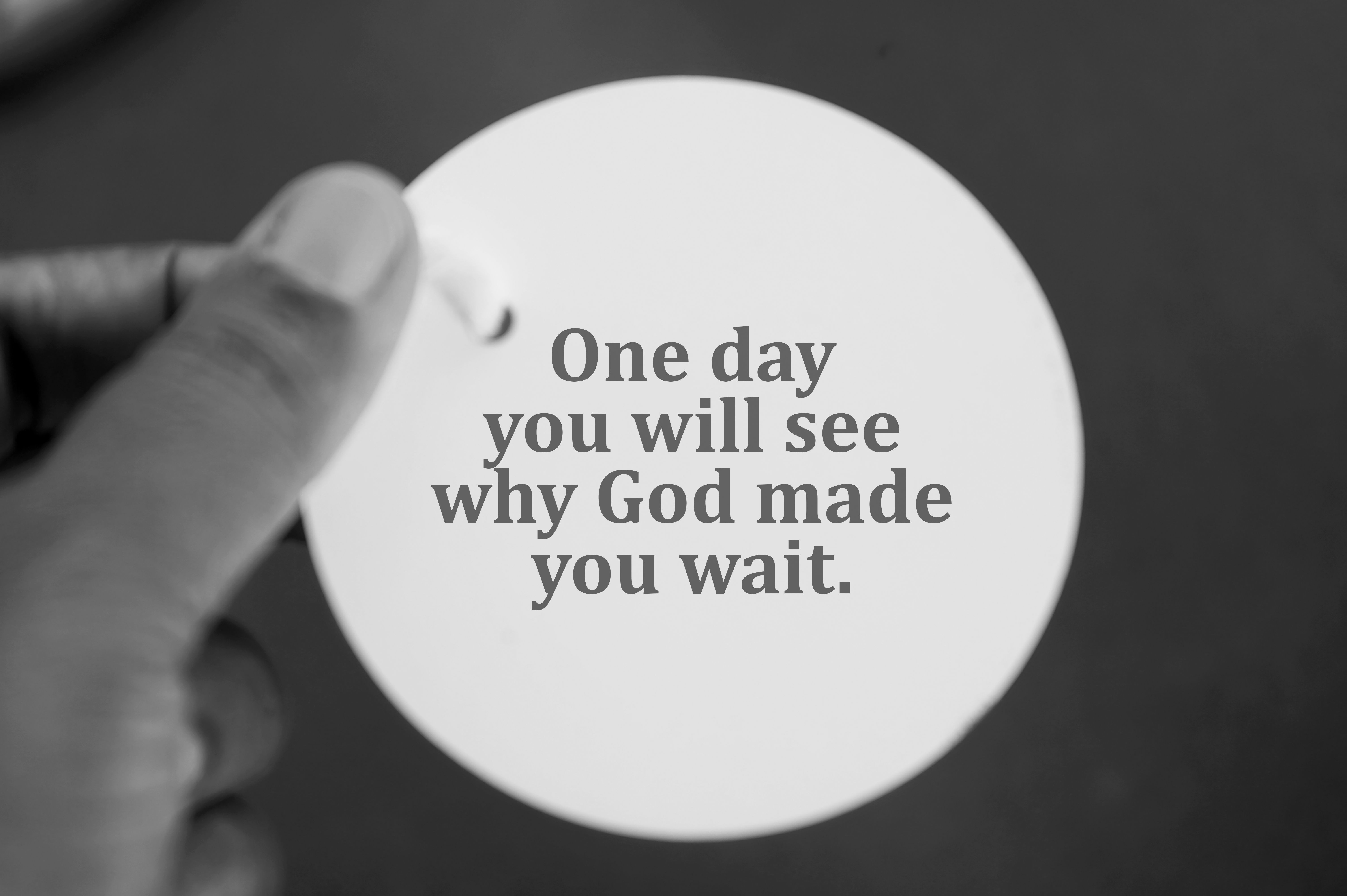 Spiritual message on white circle paper in hand - One day you will see why God made you wait. Spiritual message on white circle paper in hand - One day you will see why God made you wait.