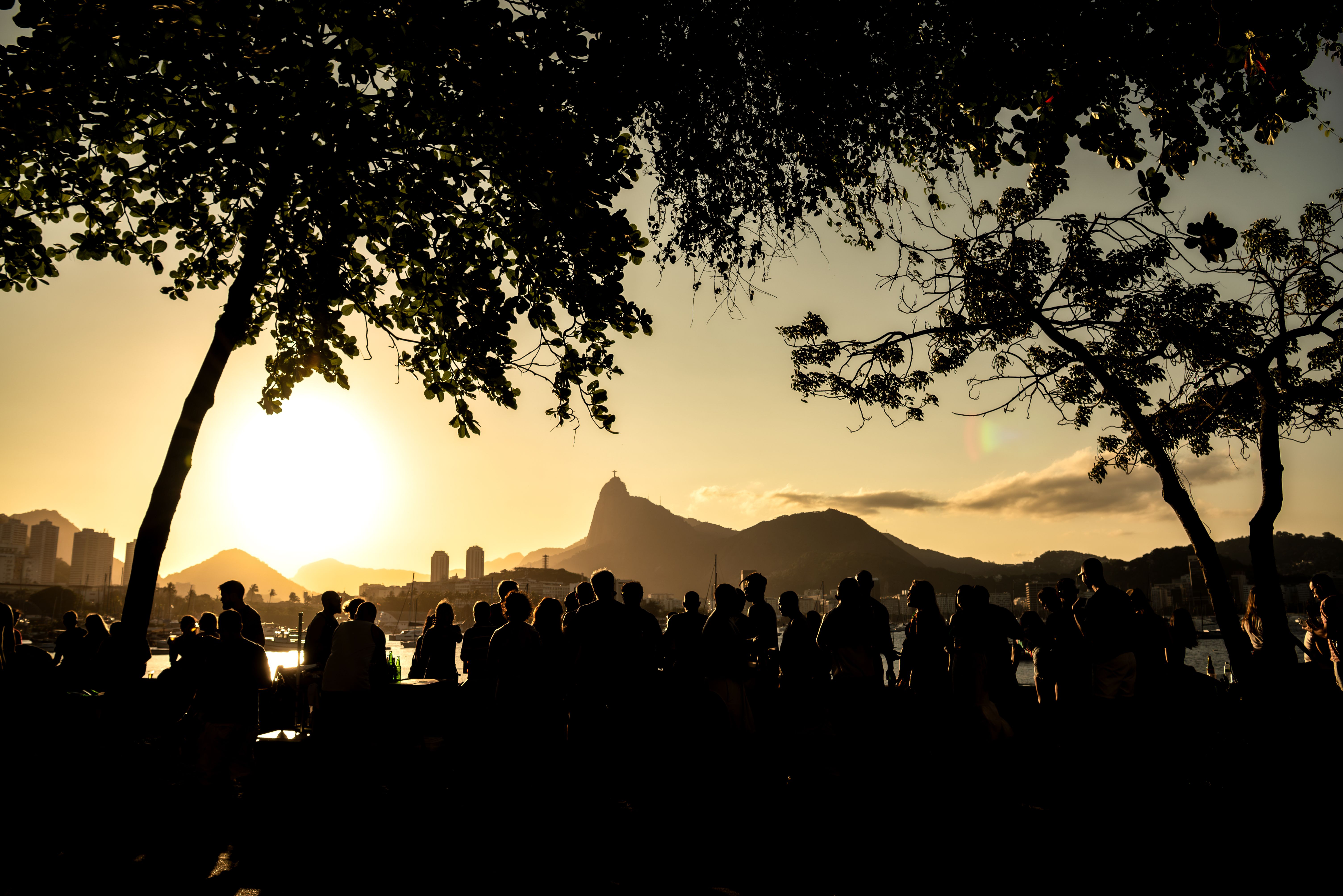 Silhouettes of People Watching the Sunset in Urca Waterfront with Corcovado Mountain - Rio de Janeiro, Brazil