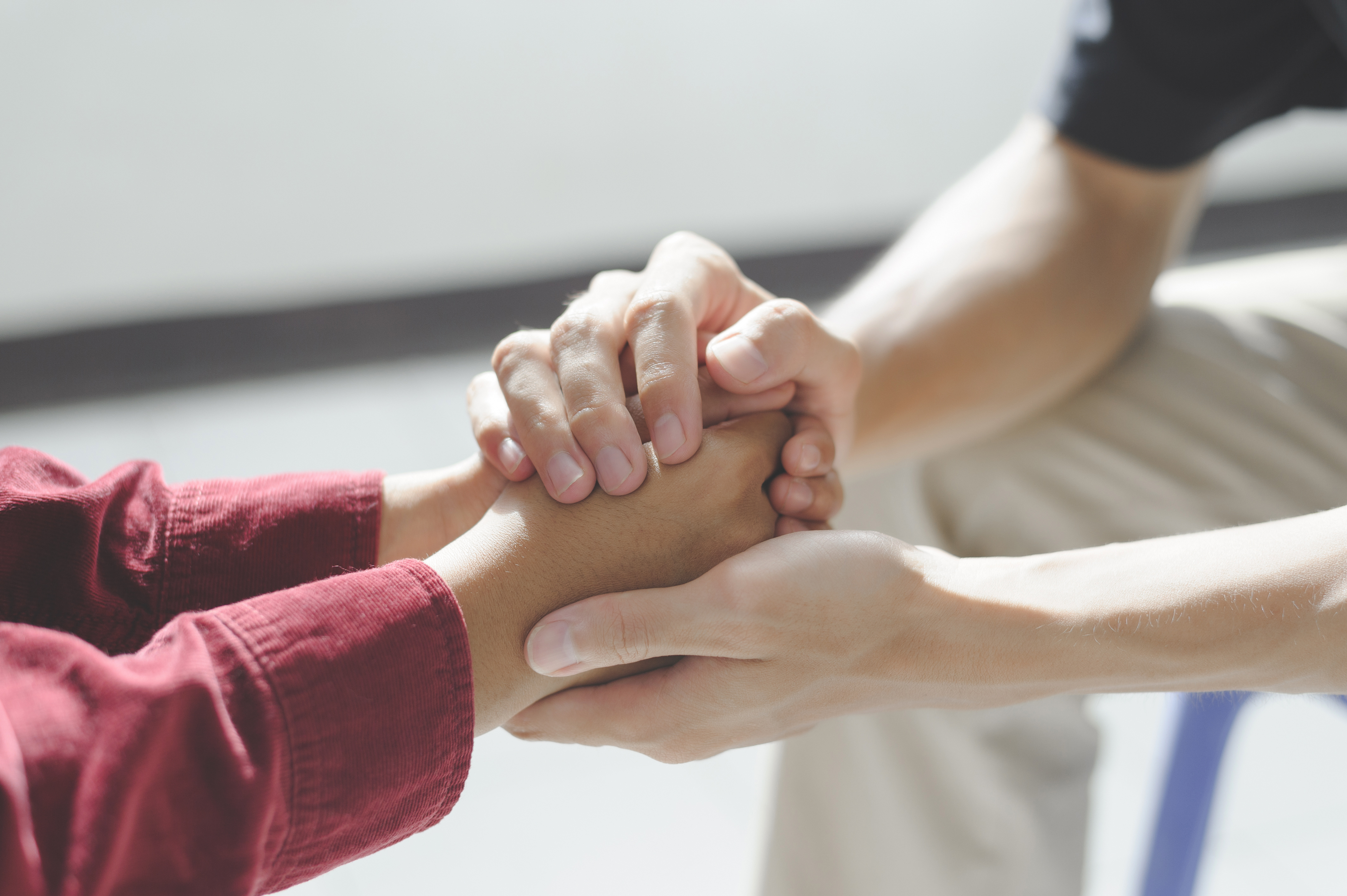 Close-up of man psychologist or psychiatrist sitting and holding hands palm of his woman patient for encouragement. PTSD Mental health concept, Close-up of man psychologist or psychiatrist sitting and holding hands palm of his woman patient for encouragement. PTSD Mental health concept,