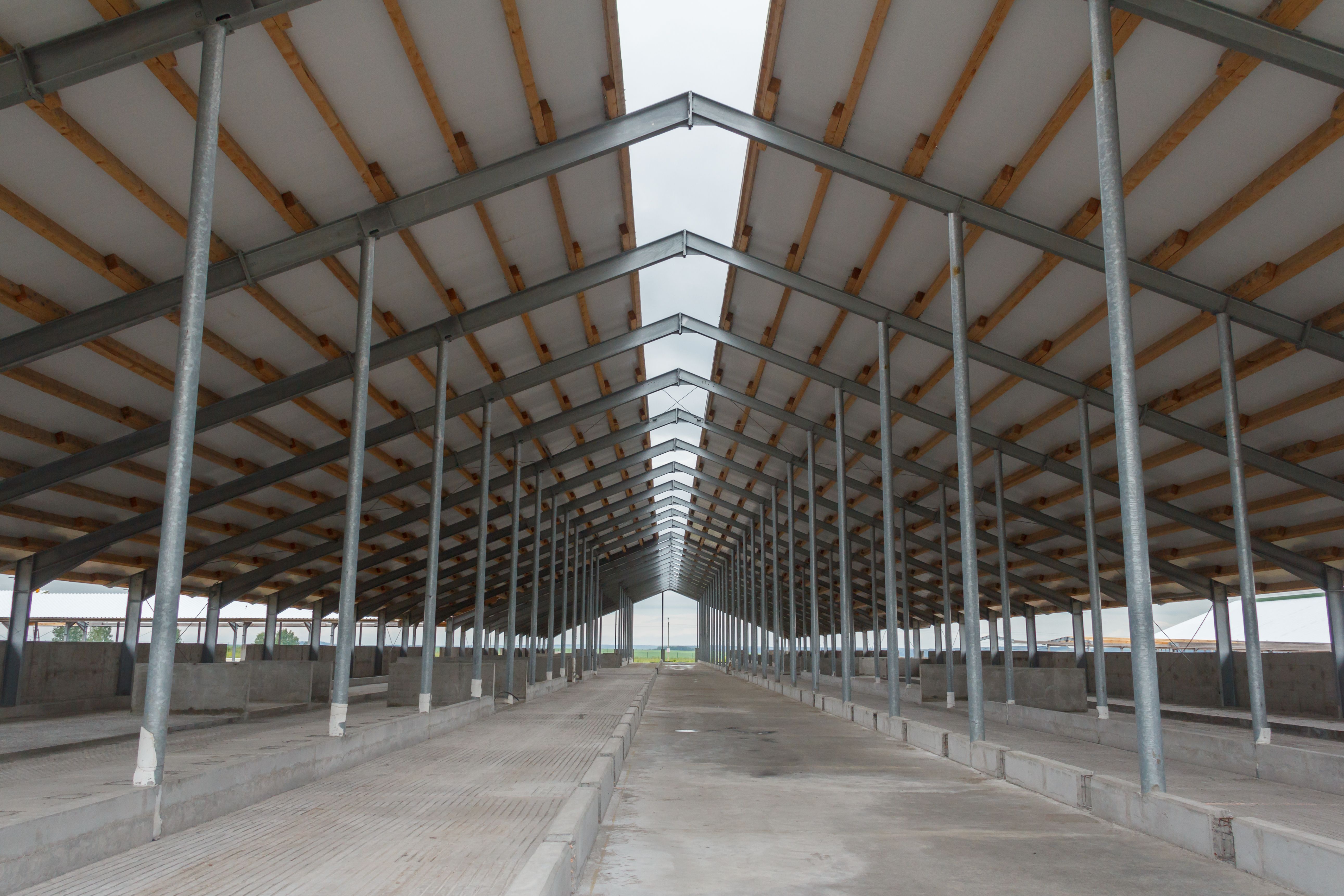 Metal frame of the building with a sandwich panel of insulation on the wall. Construction of a new industrial building. Modern Insulation of the walls of the building panels of insulation. Metal frame of the building with a sandwich panel of insulation on the wall. Construction of a new industrial building. Modern Insulation of the walls of the building panels of insulation.