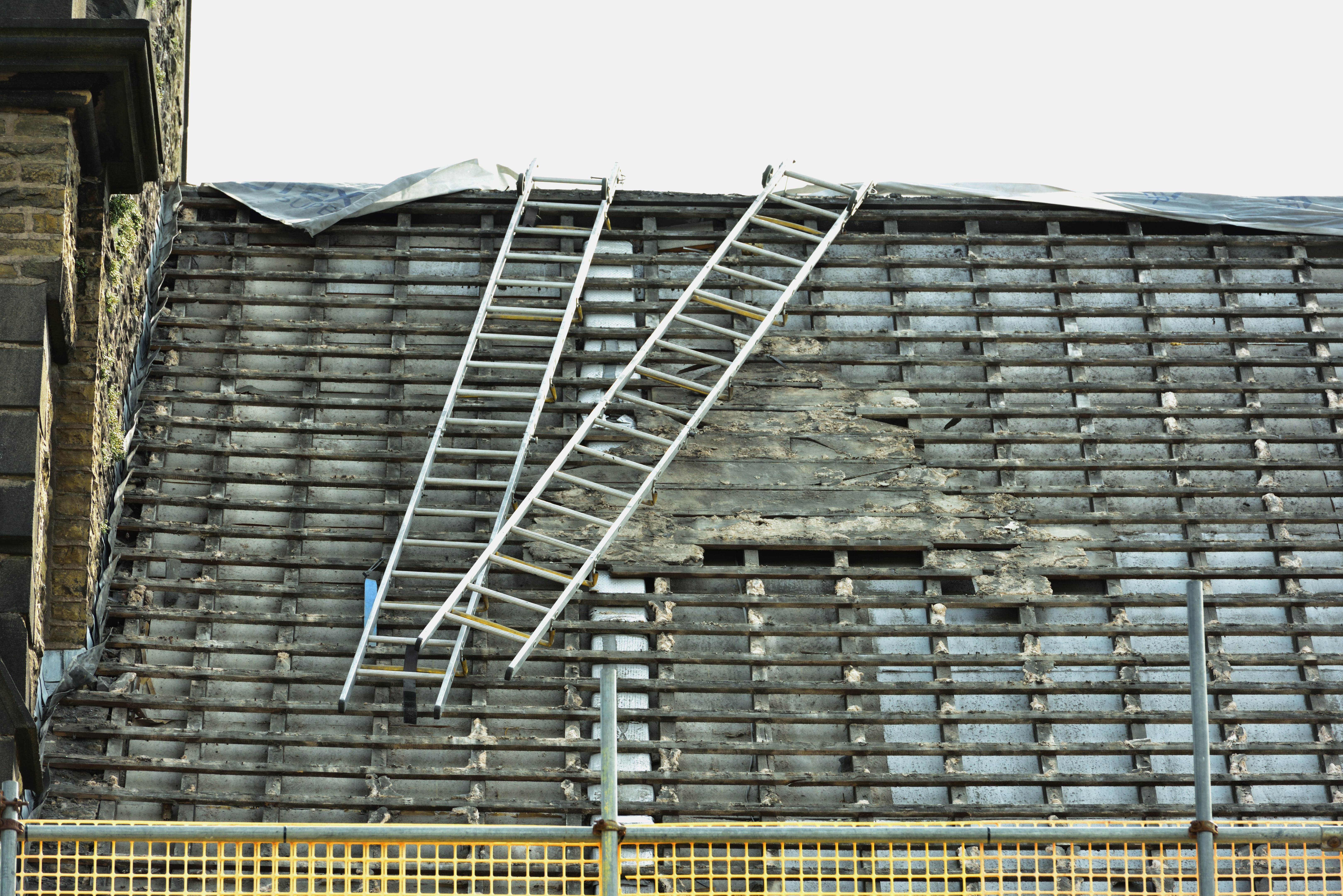 Roof ladders and scaffold on the old roof