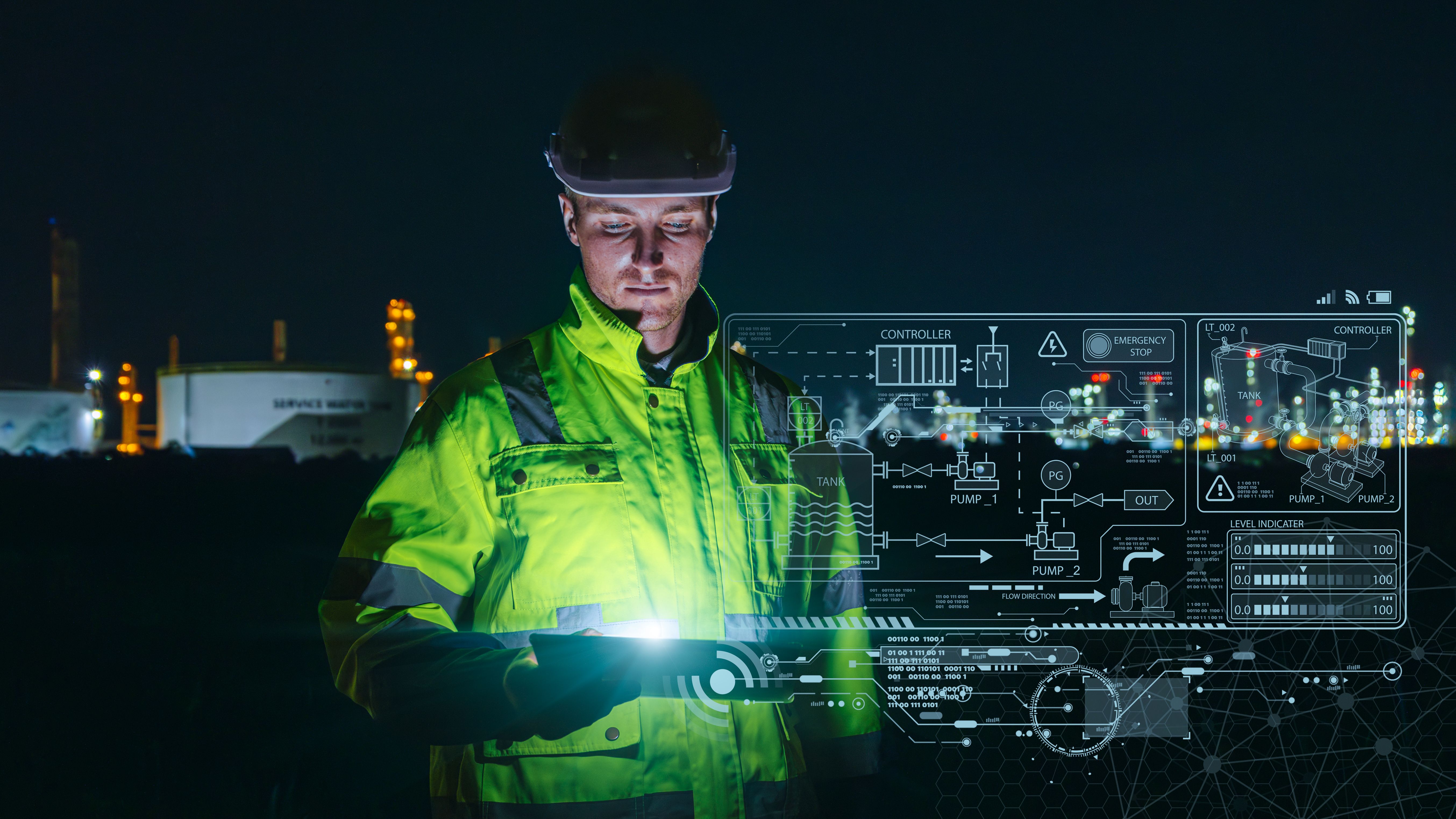 Modern technology oil and gas refinery engineer worker using advance digital device monitor service in petroleum industry pipe plant.
