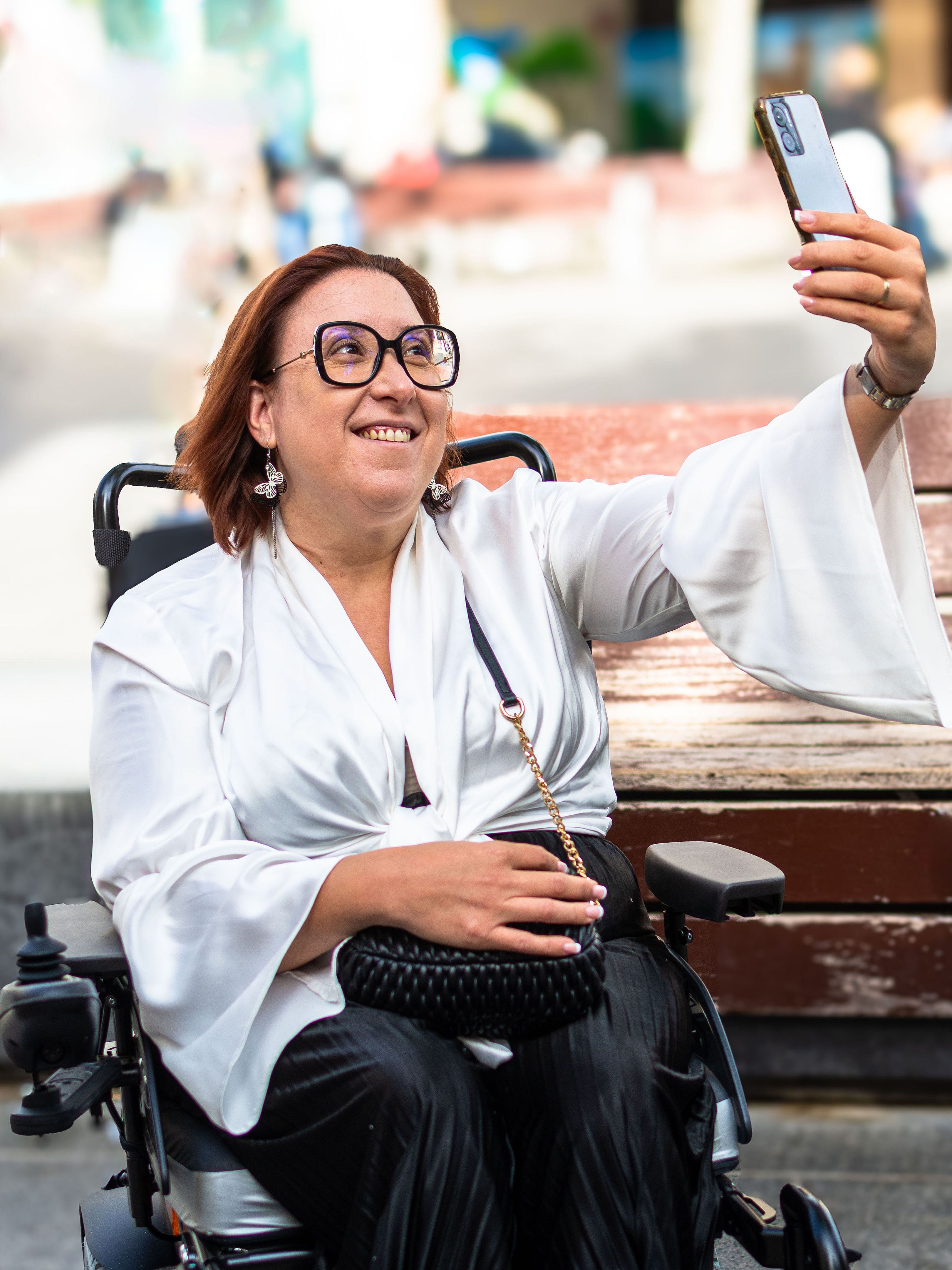 Happy Wheelchair User Taking a Selfie in the Park