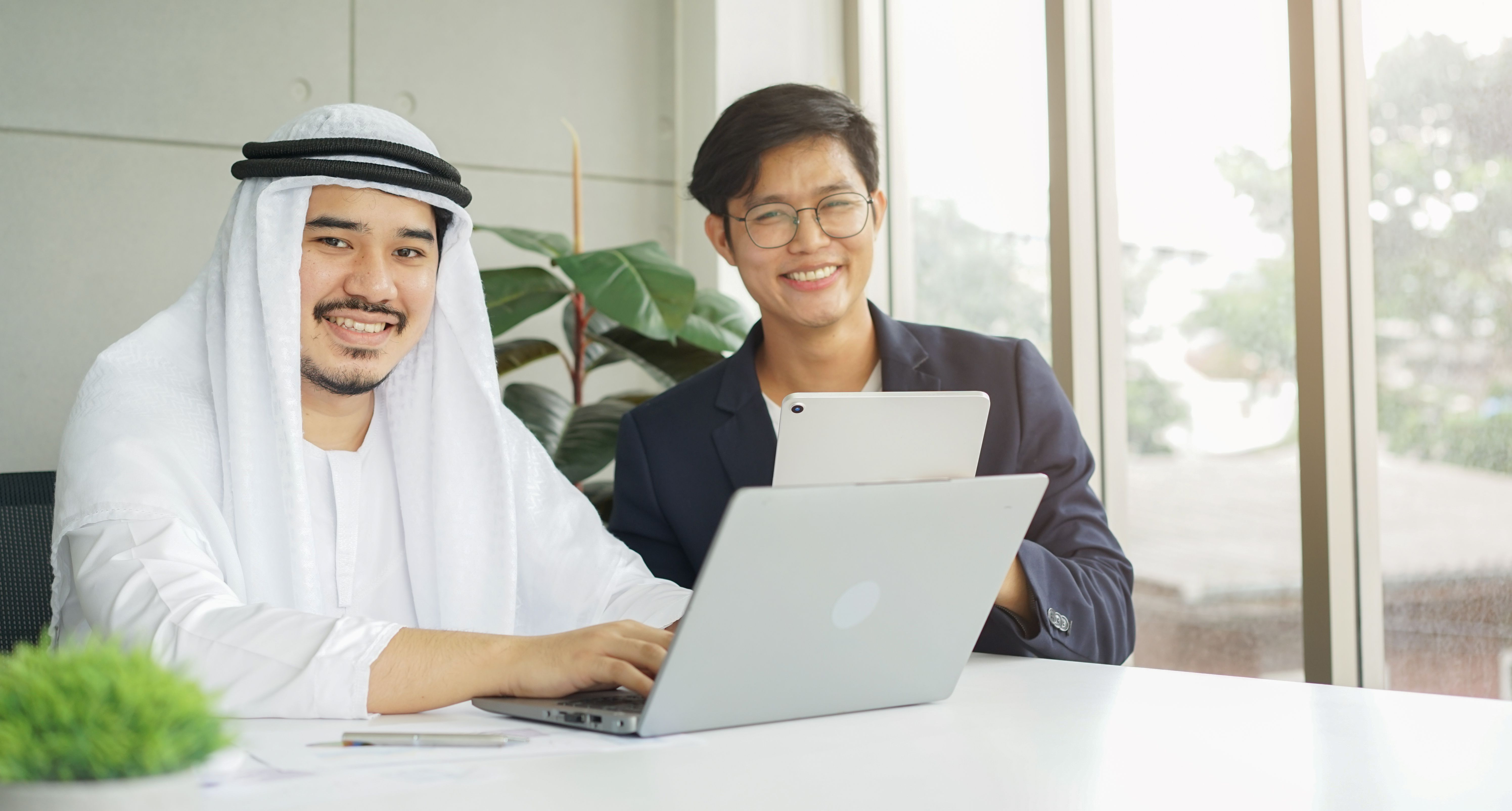 close up group of Arab investor with asian businessman look at camera in office to meeting global investment project in board room for working multiracial group concept