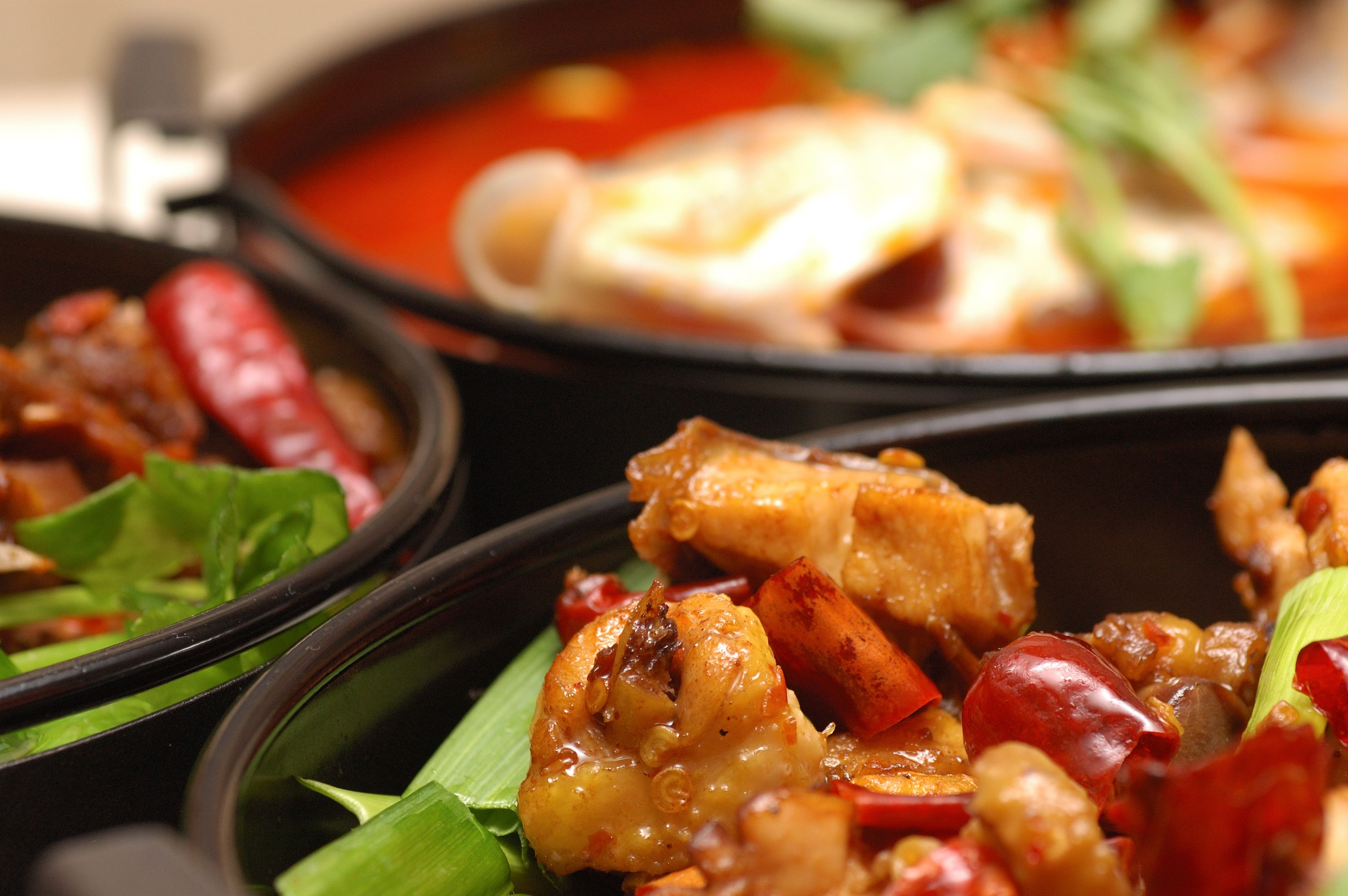 Chinese food in black bowls on table Chinese food in black bowls on table