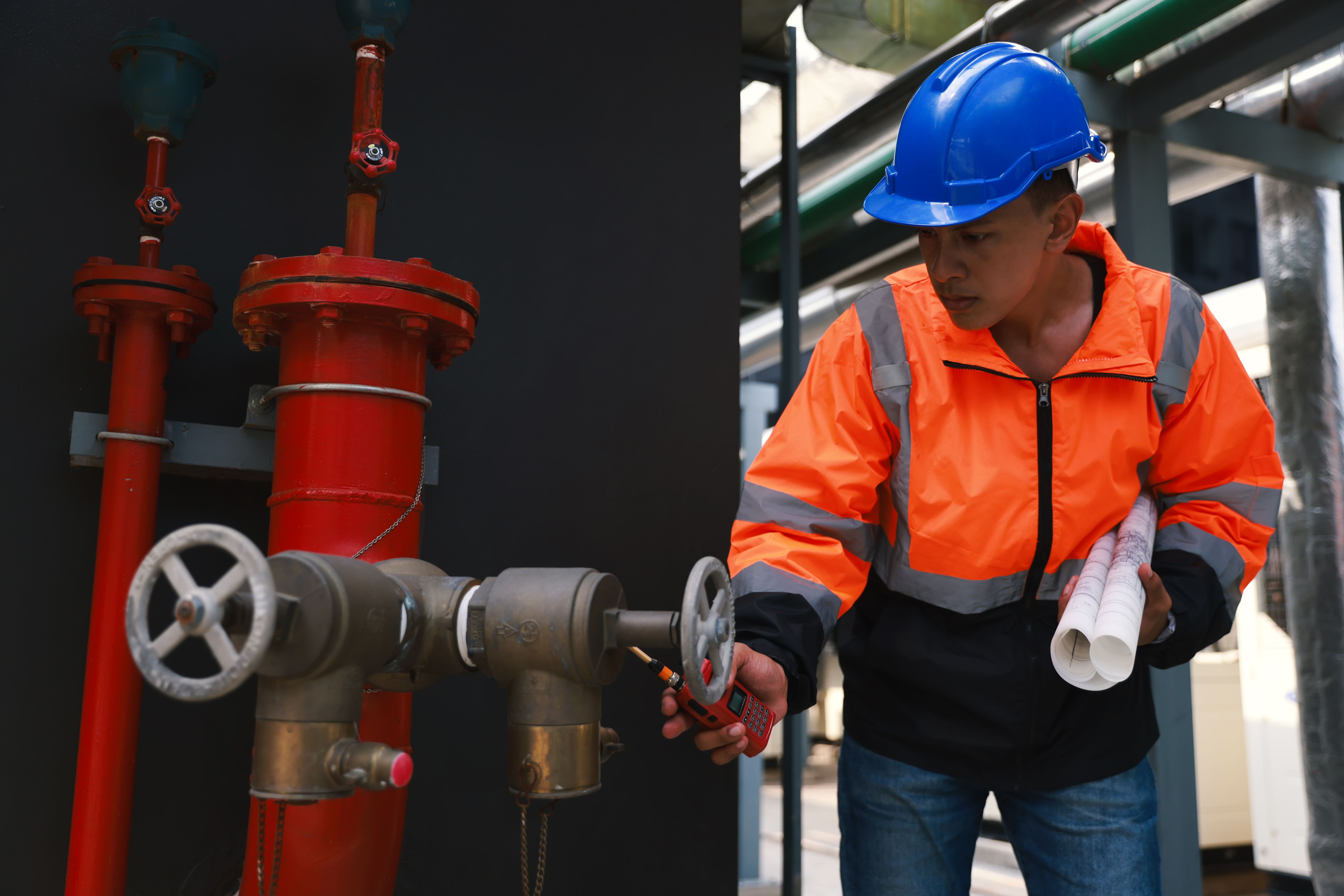 Maintenance engineer working with digital tablet and drawing check Fire hydrant system. Engineering and factory concept