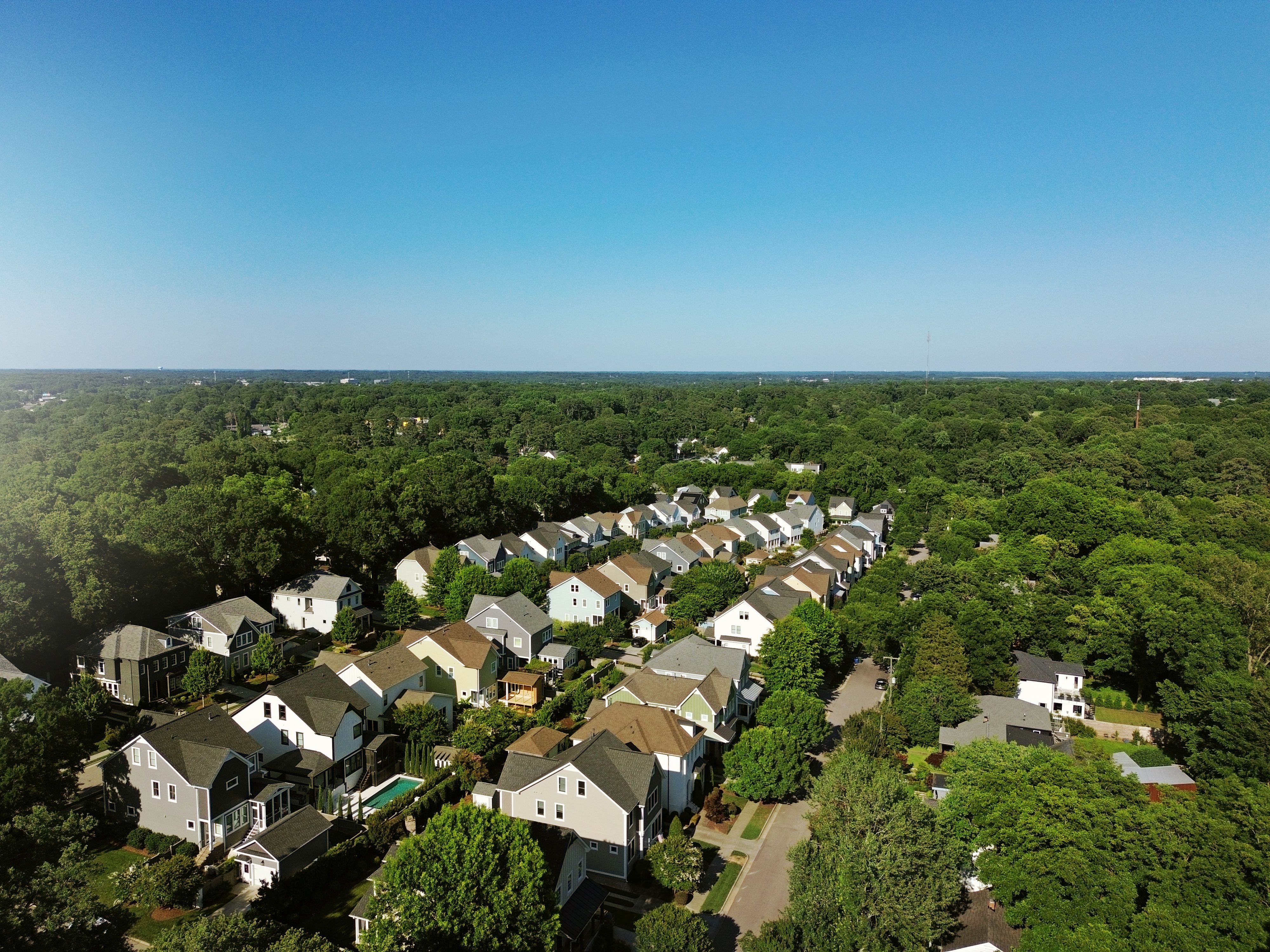 Aerial view of new homes in a housing development with tree lined streets in Raleigh North Carolina