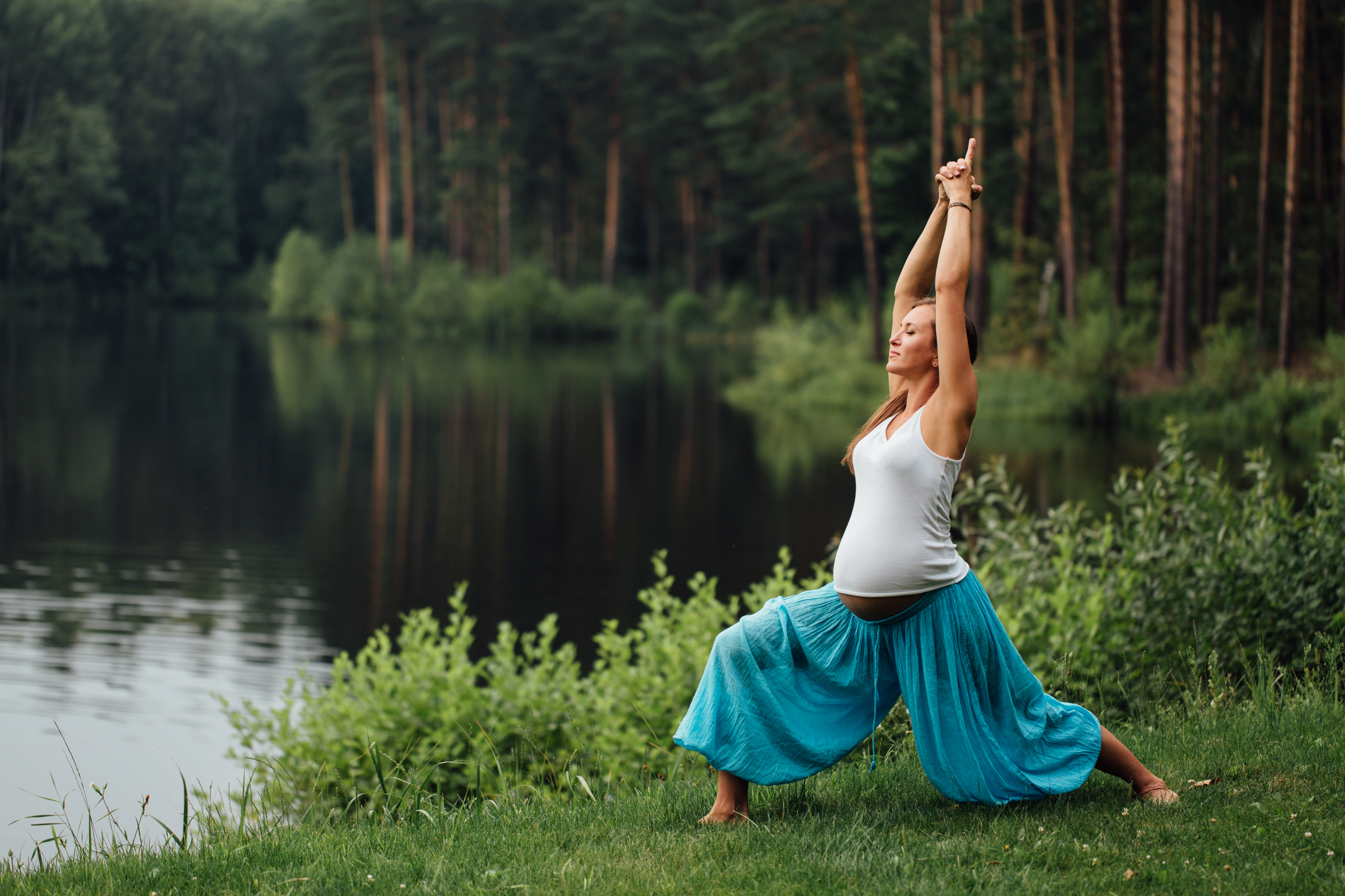 pregnant yoga prenatal maternity doing different exercises. in the park
