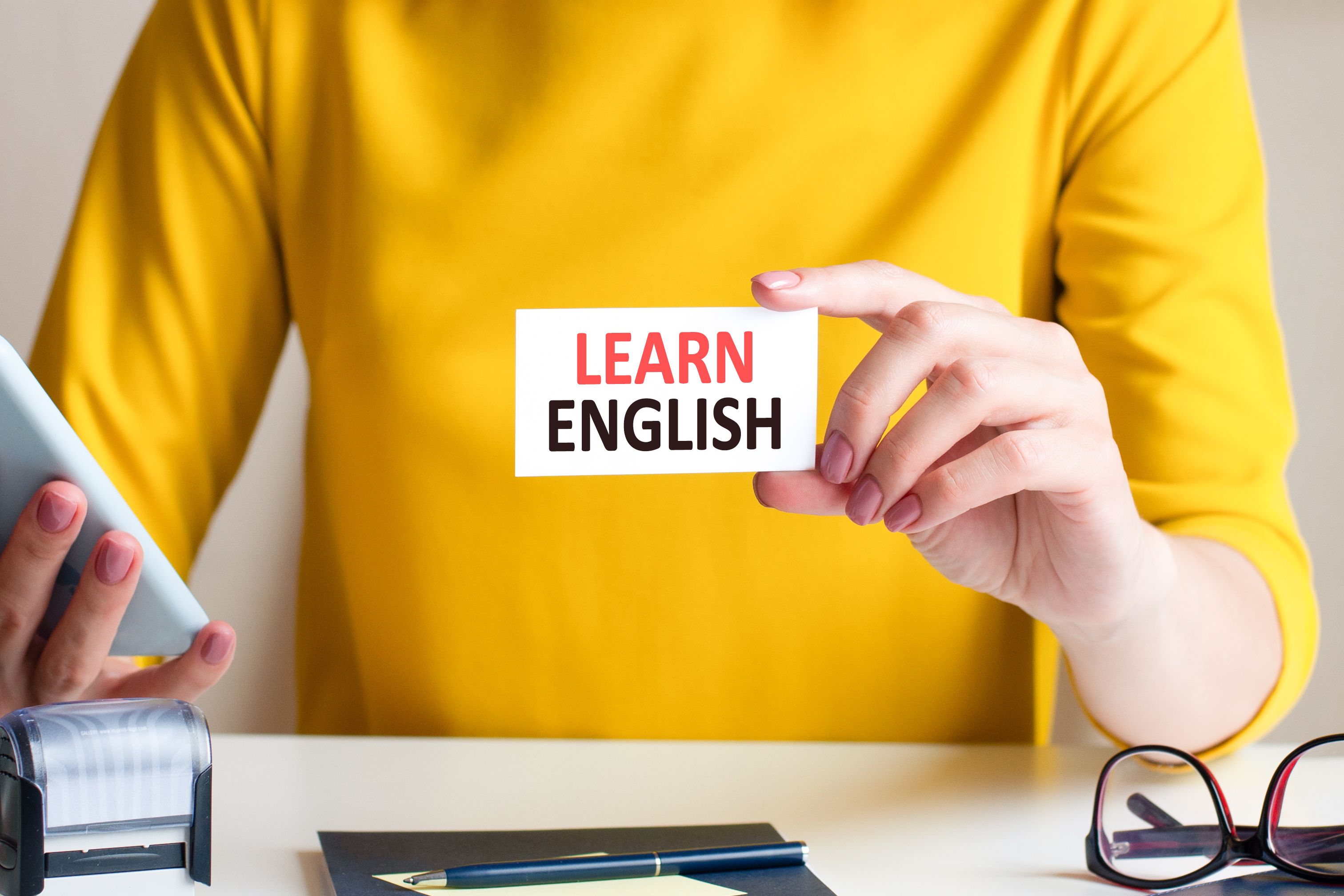 learn english written on a paper card in woman hand, concept learn english written on a paper card in woman hand, concept