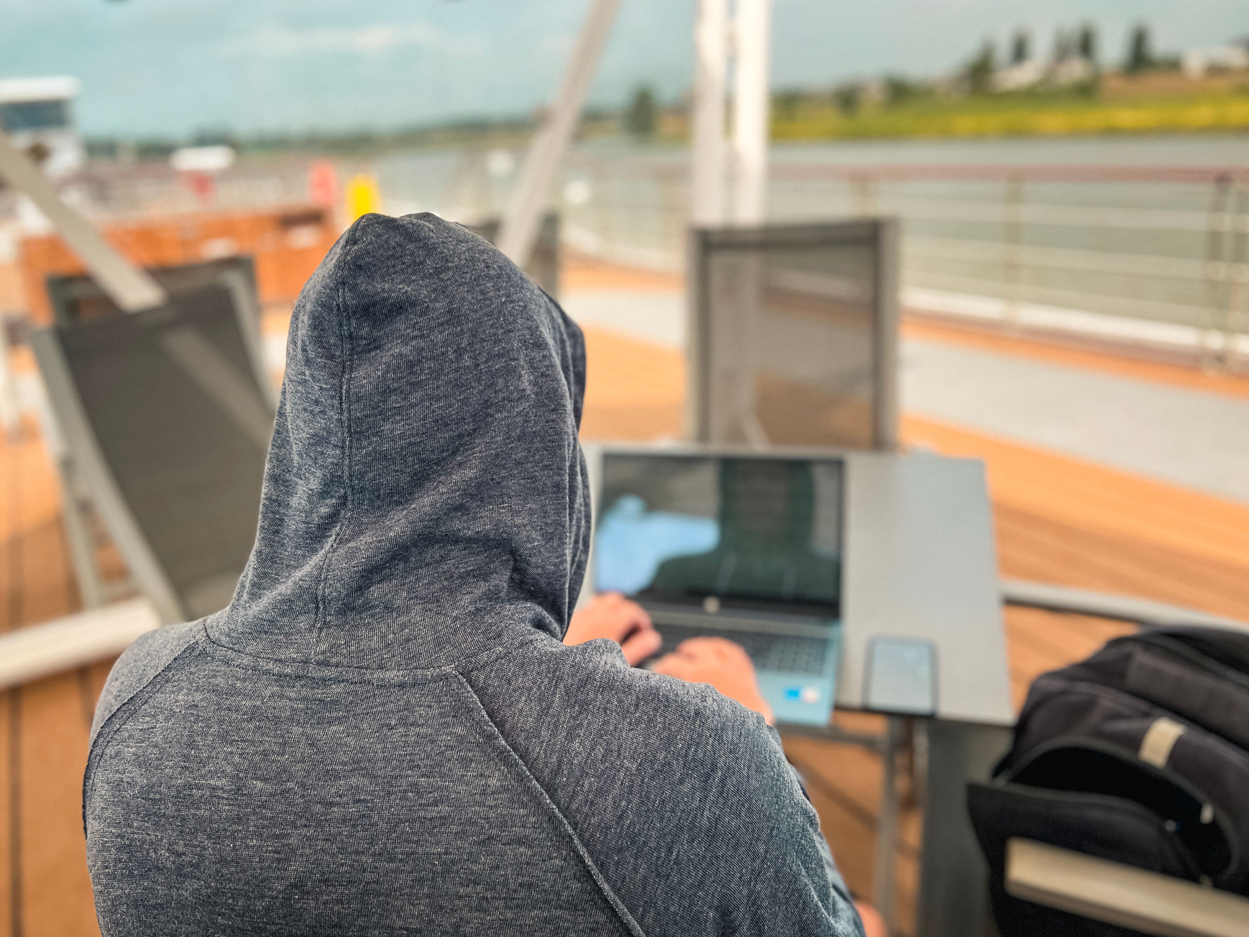 Man Works on His Laptop Computer on a Moving Boat