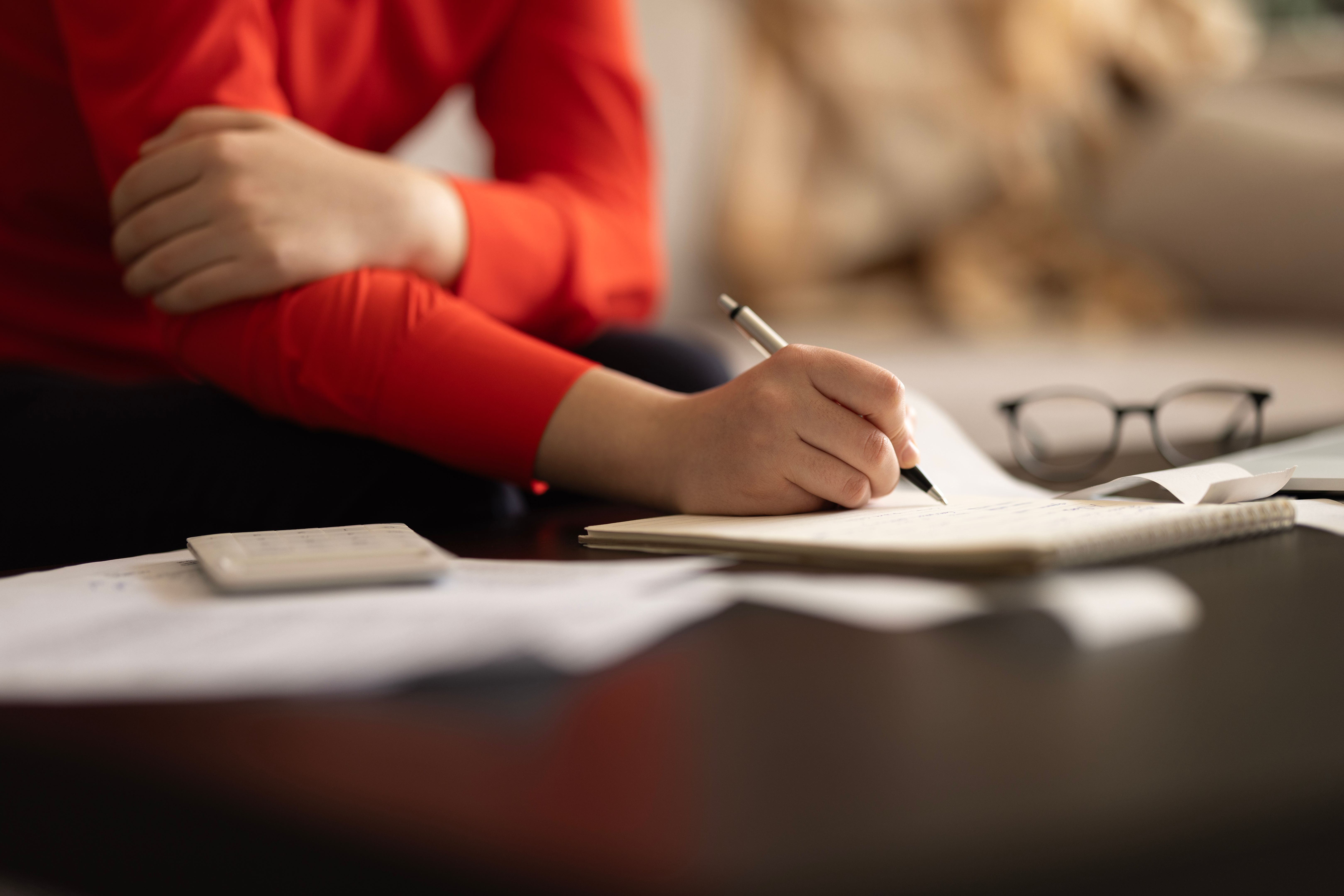 Woman is calculating the cost of the bill.
