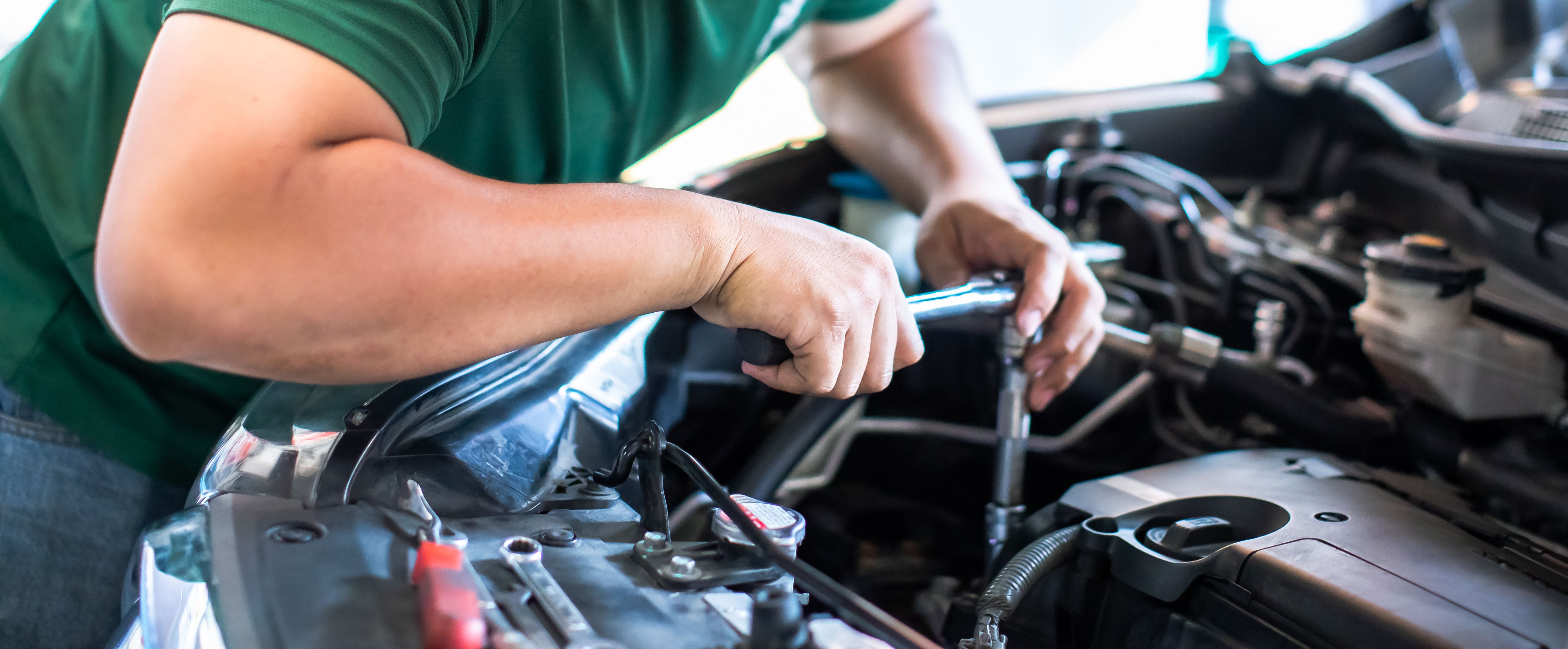 mechanic checking alternator