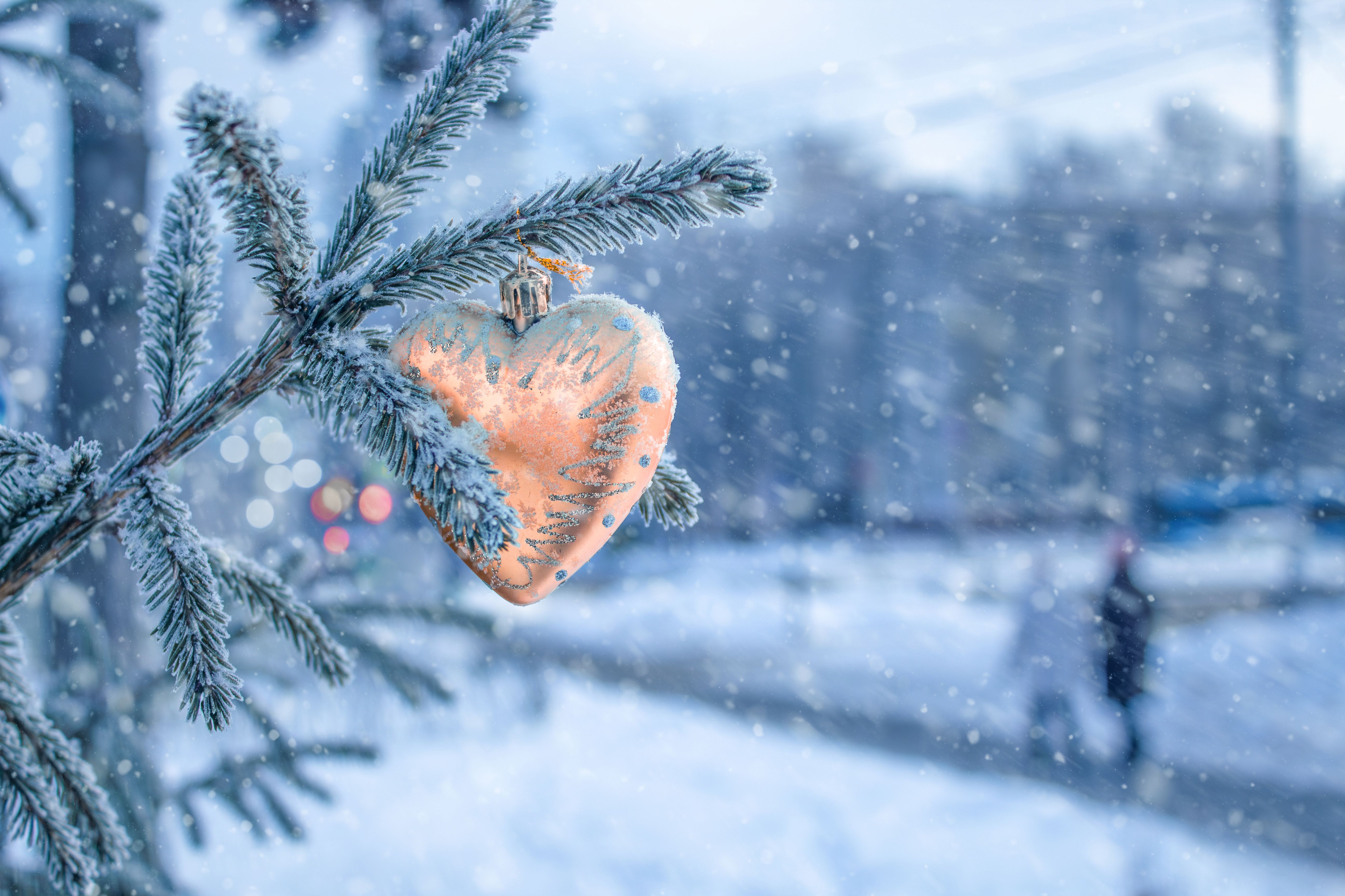 Winter cityscape with people strolling and Christmas tree. toy in shape of heart. Valentine's Day. New Year. peach color, color of year