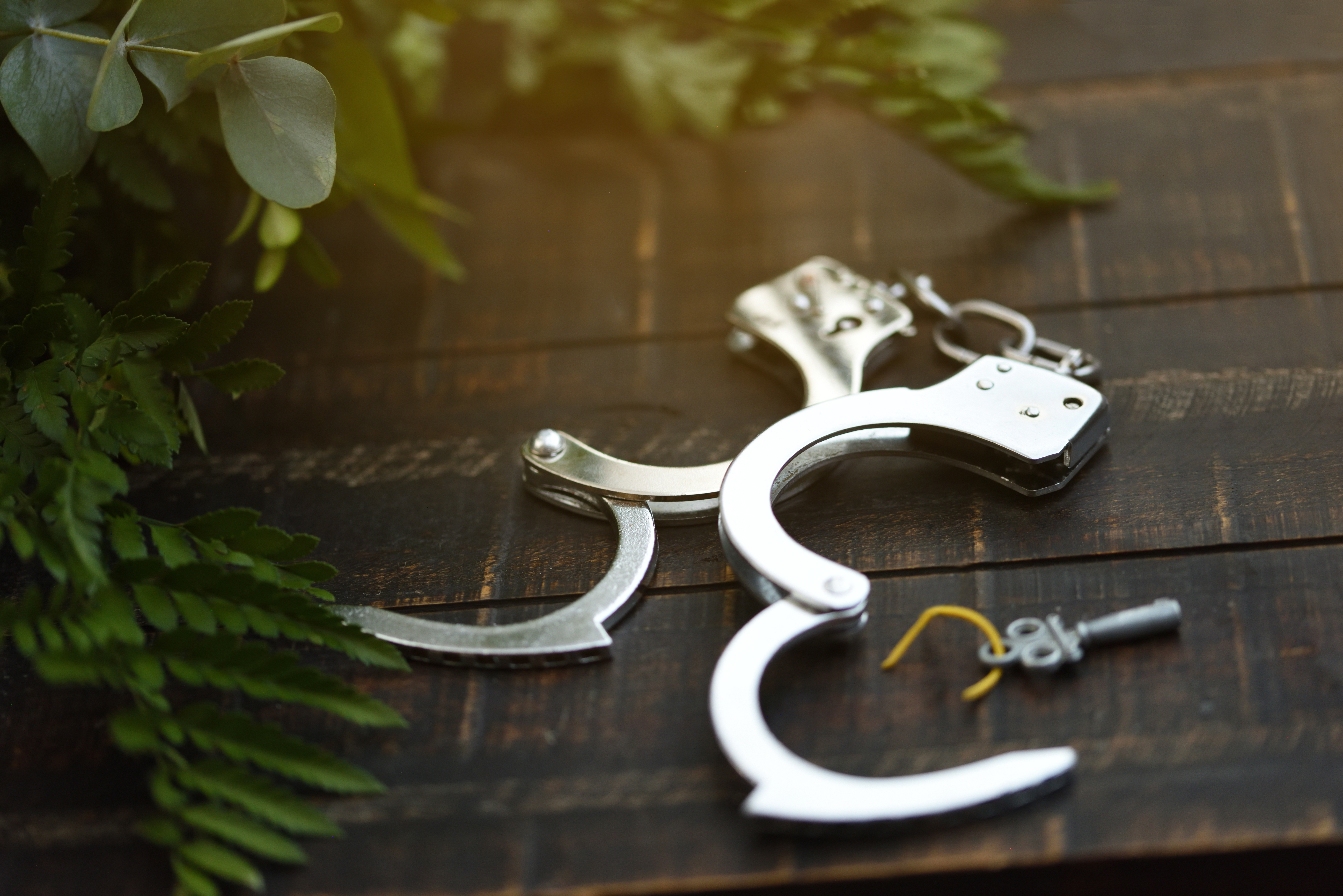 Open handcuffs with the key next to them, conceptual and psychological background, freeing oneself
