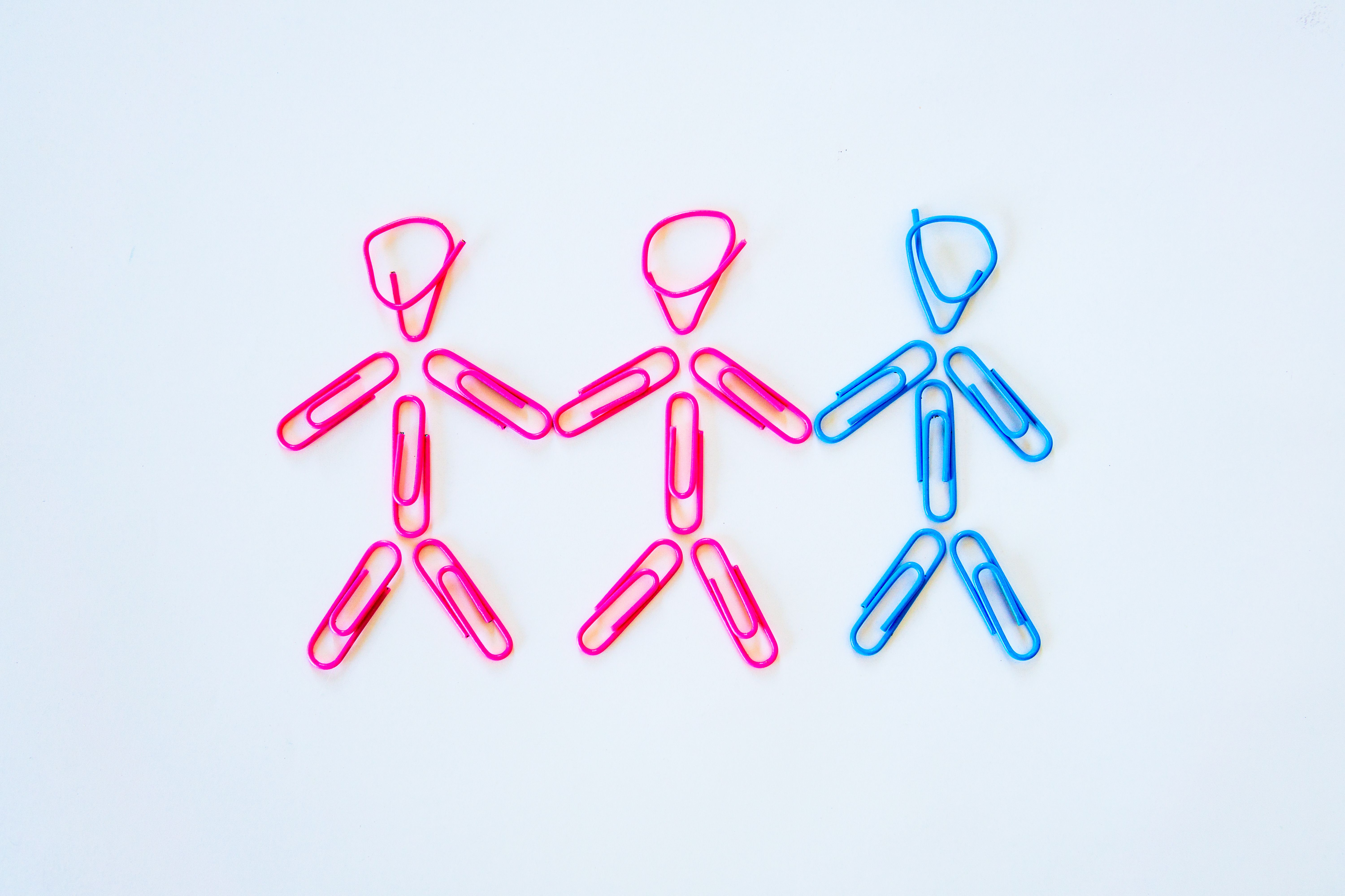 Polygamous bisexual relationship holding hands lowered concept from paper clips