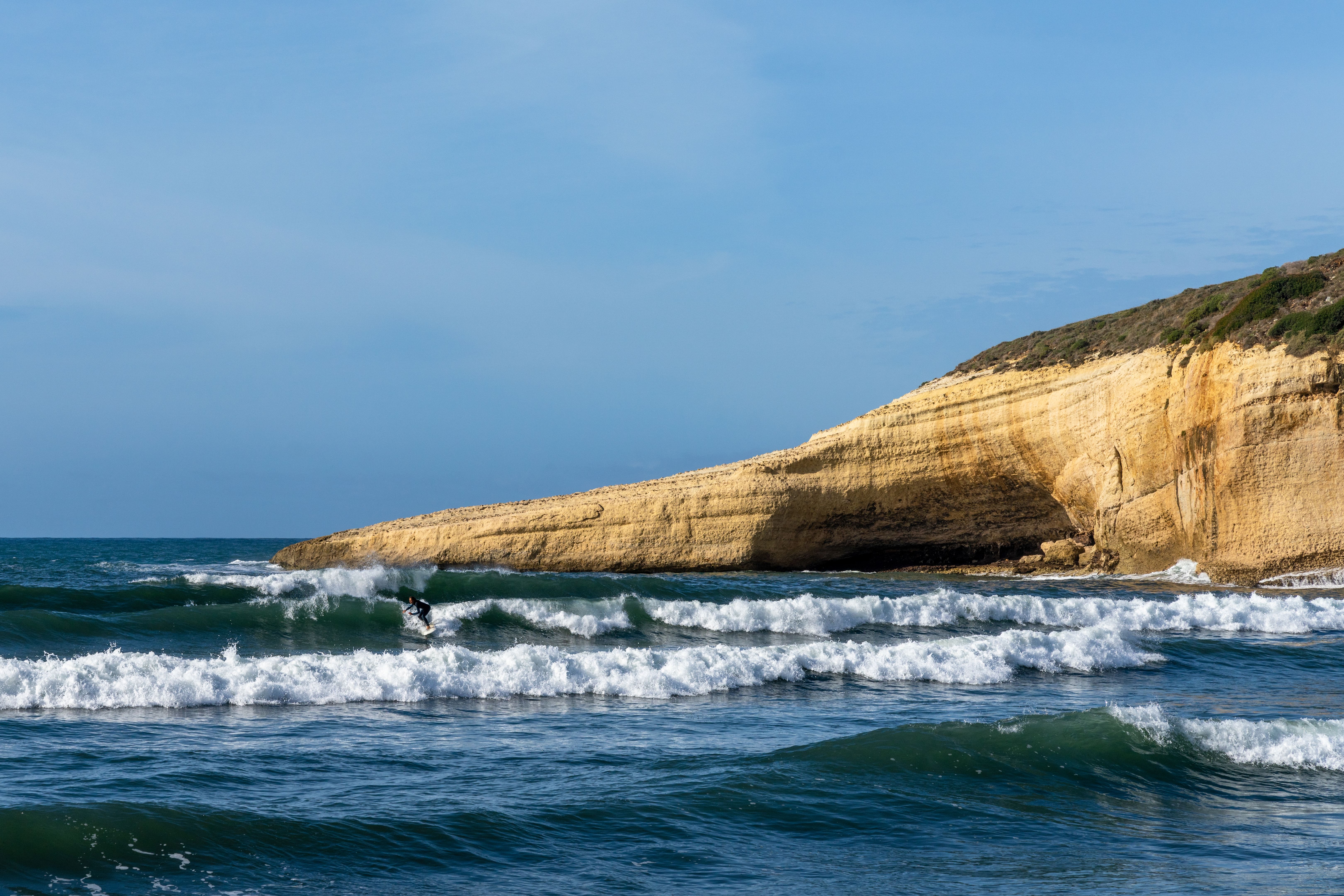 surfer enjoying good waves on the west coast of Sardinia during a good winter swell