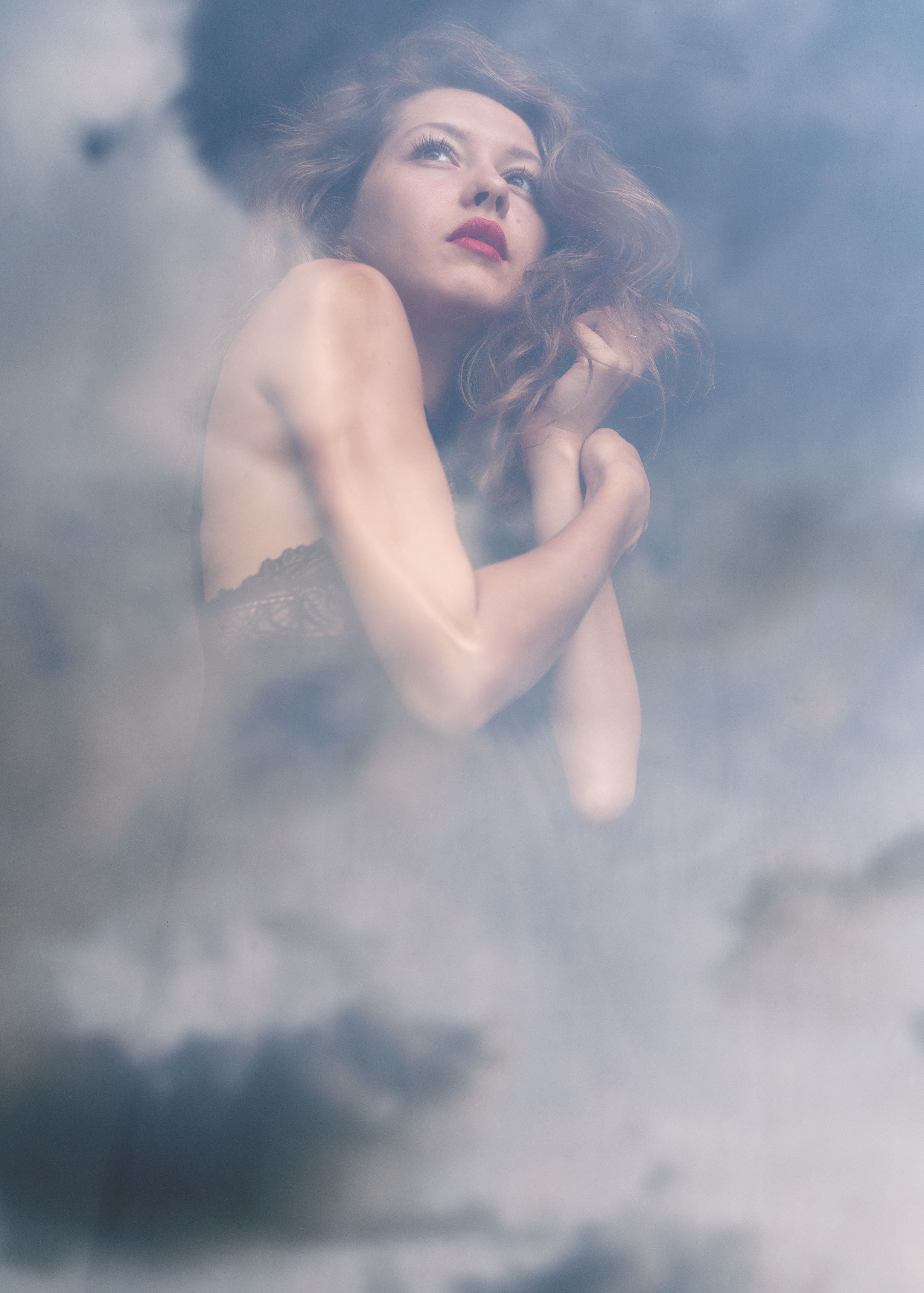Young stylish pretty girl woman with red lips in black lingerie, fashion and beauty portrait. Double exposure shot, sky reflection with clouds