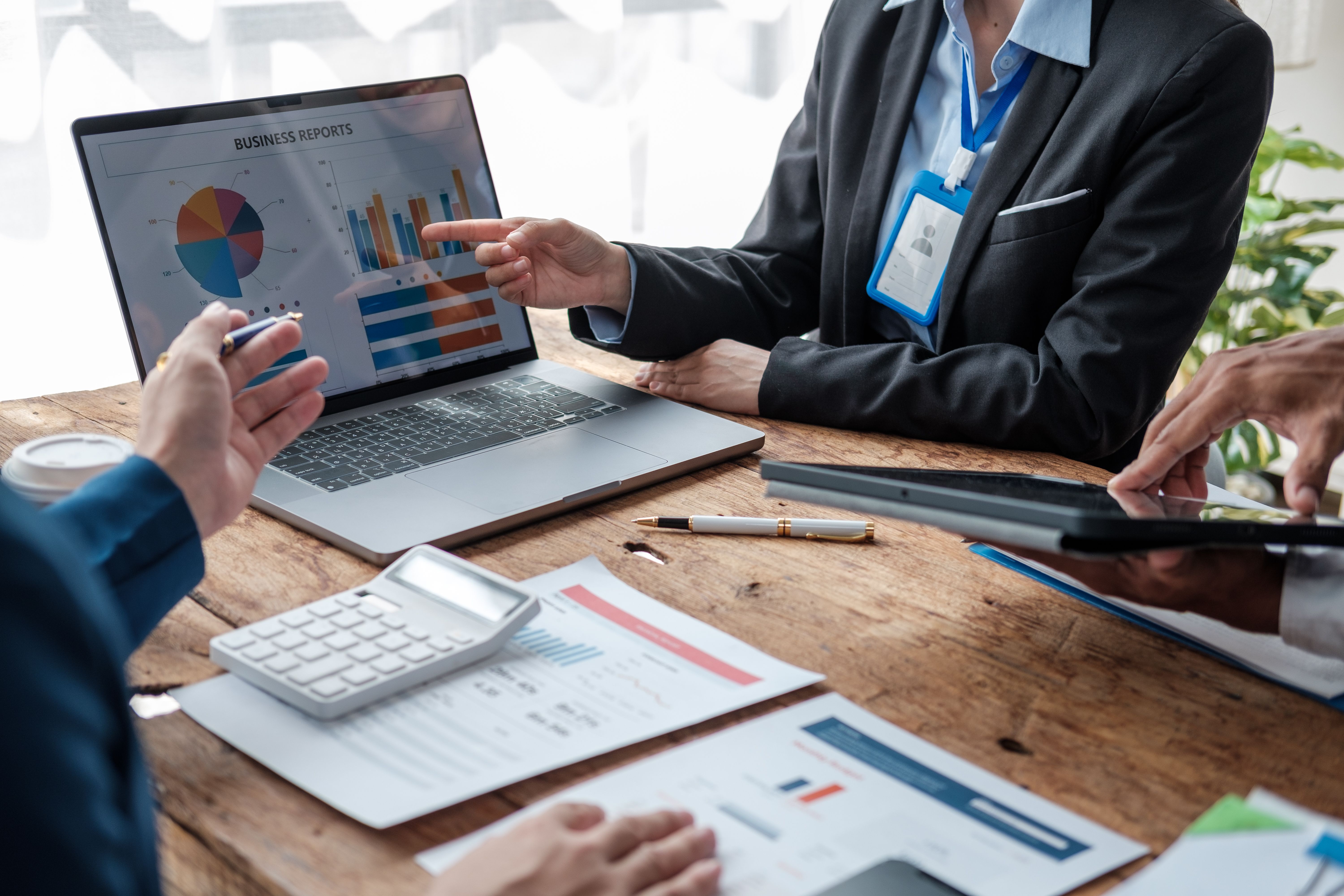 Colleagues meeting discuss business project planning, marketing strategies, and financial report analysis for business investment planning. Colleagues meeting discuss business project planning, marketing strategies, and financial report analysis for business investment planning.