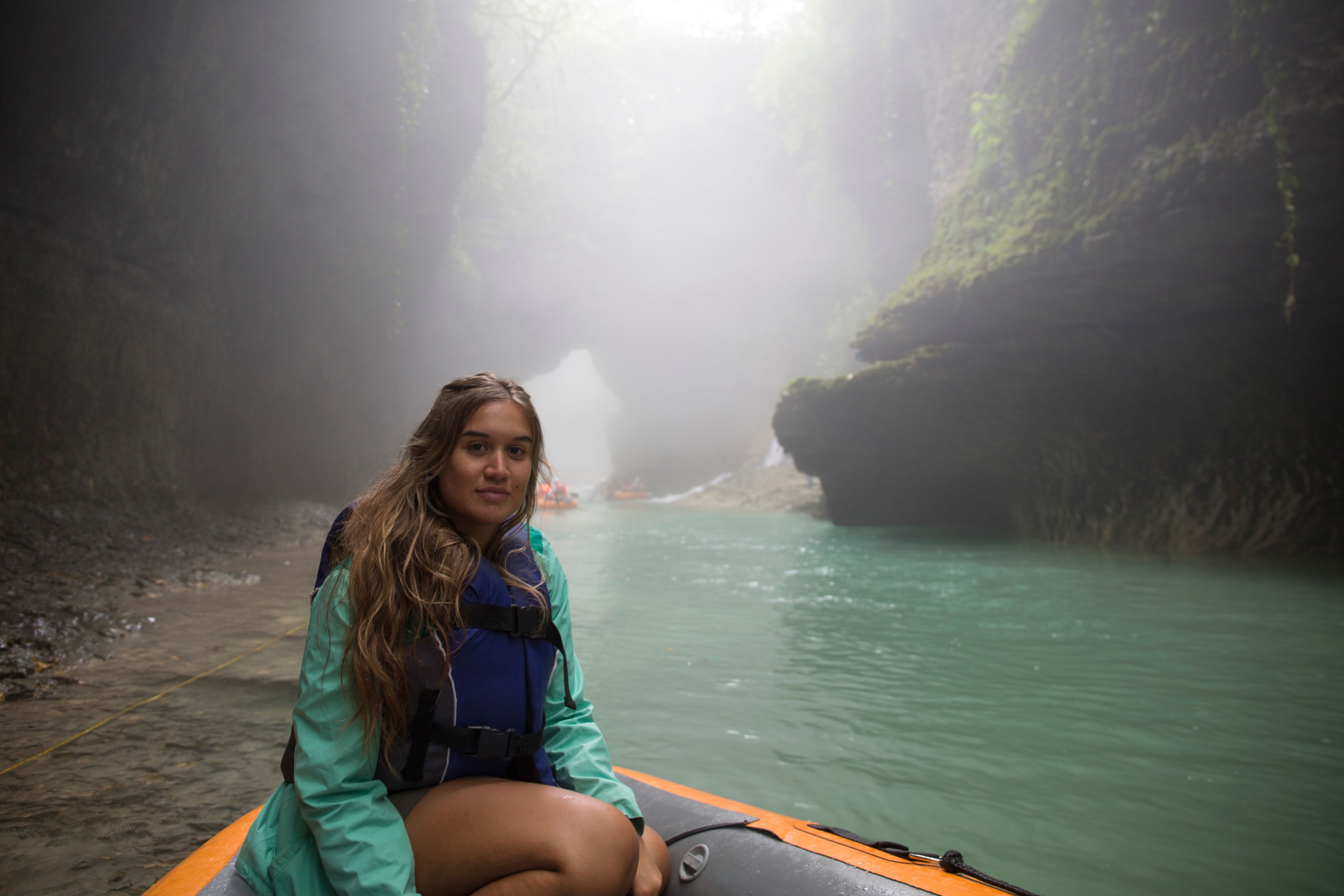 Young woman explores water canyon