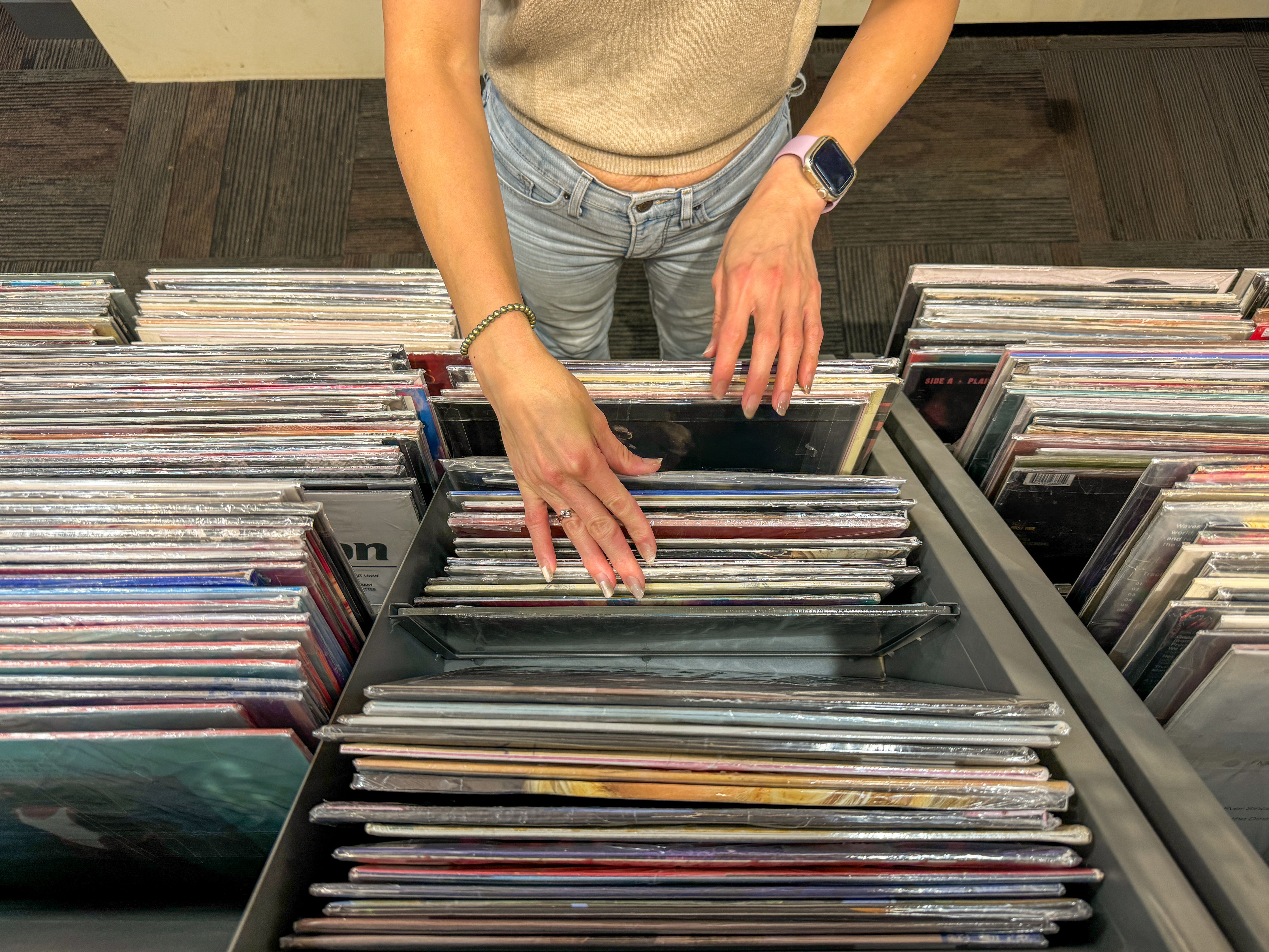 Female hand selecting vinyl records