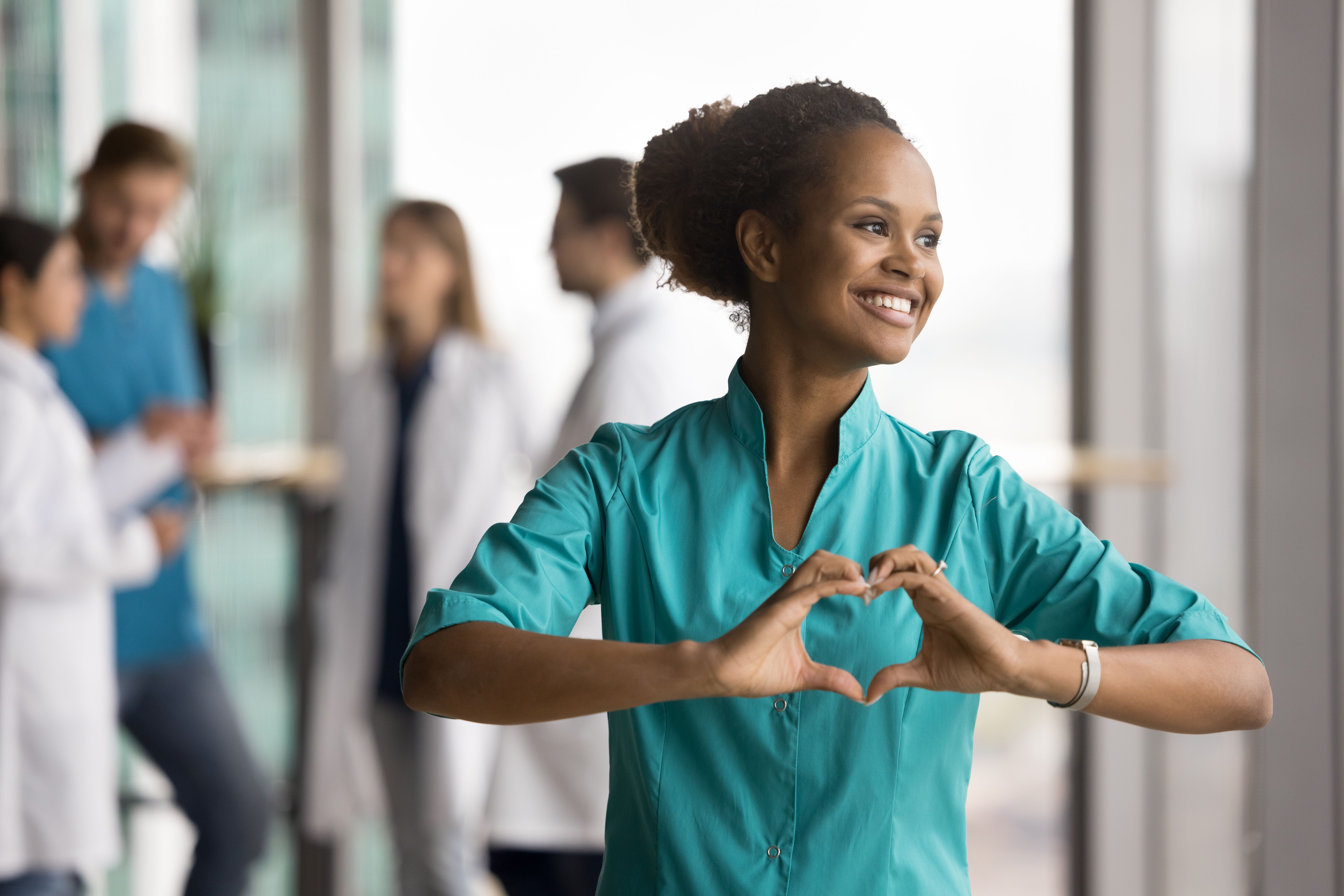 Happy dreamy beautiful African doctor woman promoting cardio healthcare checkup Happy dreamy beautiful African doctor woman promoting cardio healthcare checkup