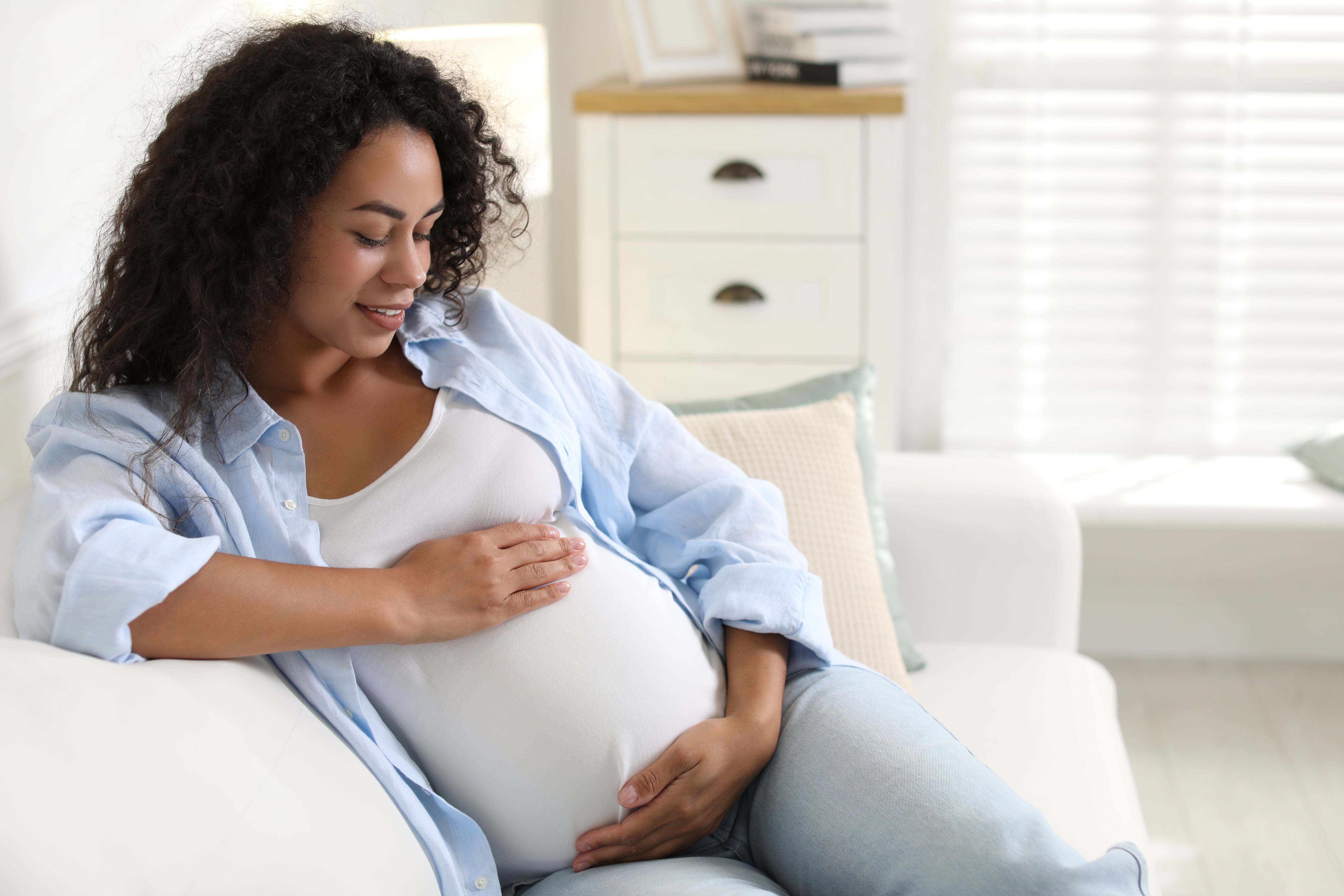 Pregnant mother sitting on couch