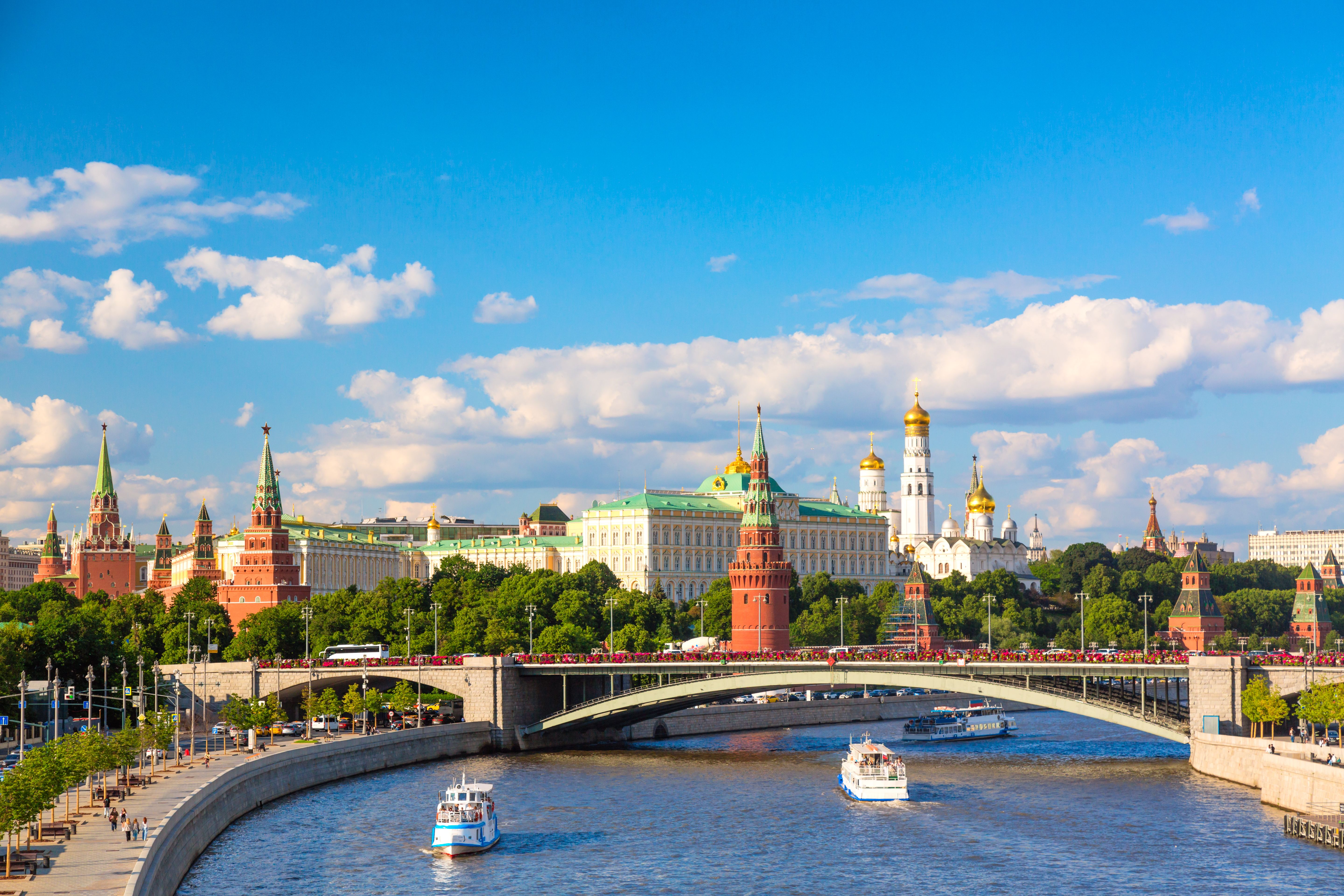View of Moscow Kremlin, Moscow River, sightseeing ships and Big Stone bridge during summer sunny day. Landmark in Moscow, Russia View of Moscow Kremlin, Moscow River, sightseeing ships and Big Stone bridge during summer sunny day. Landmark in Moscow, Russia