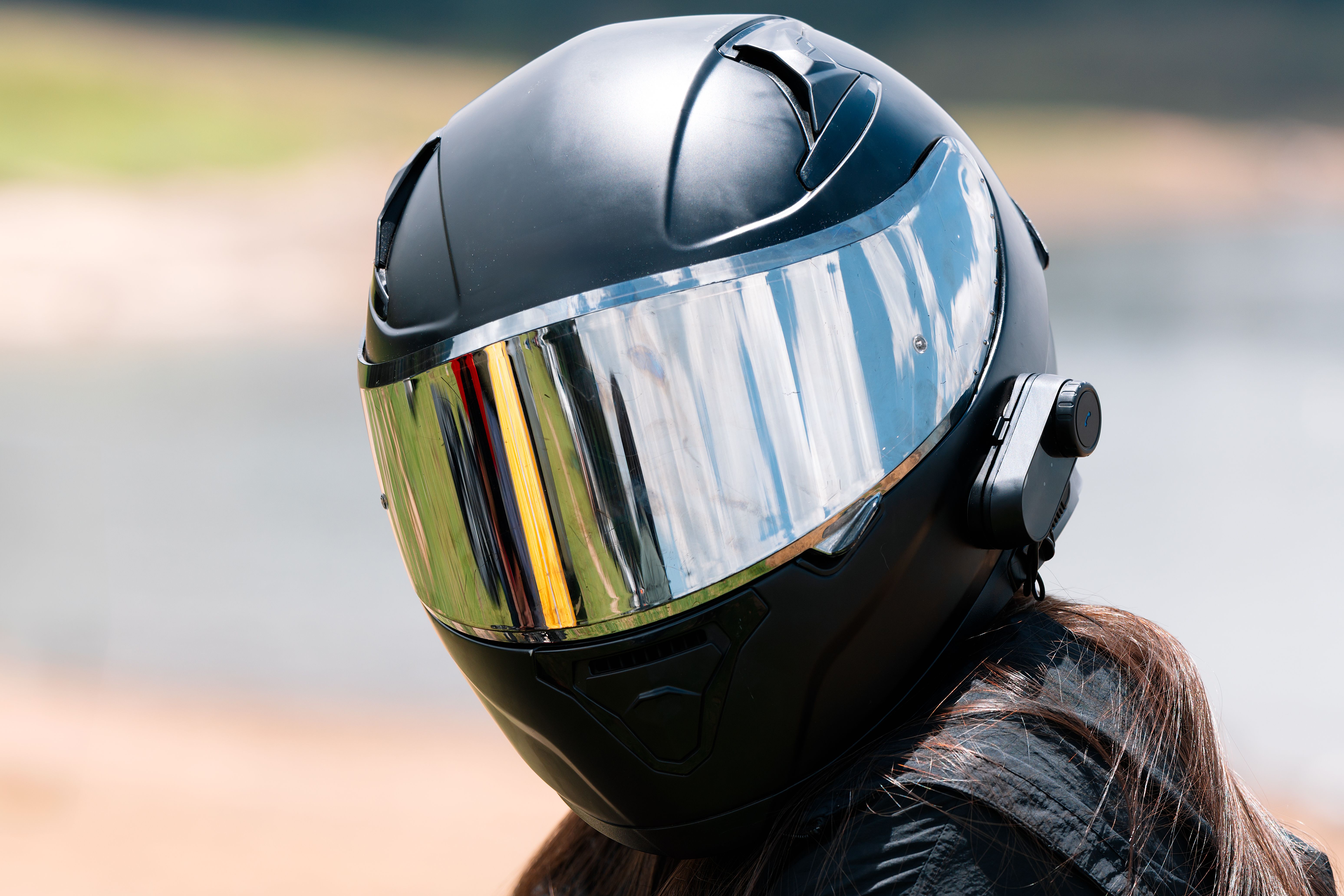 Motorcyclist wearing a modern helmet with Bluetooth intercom Motorcyclist wearing a modern helmet with Bluetooth intercom