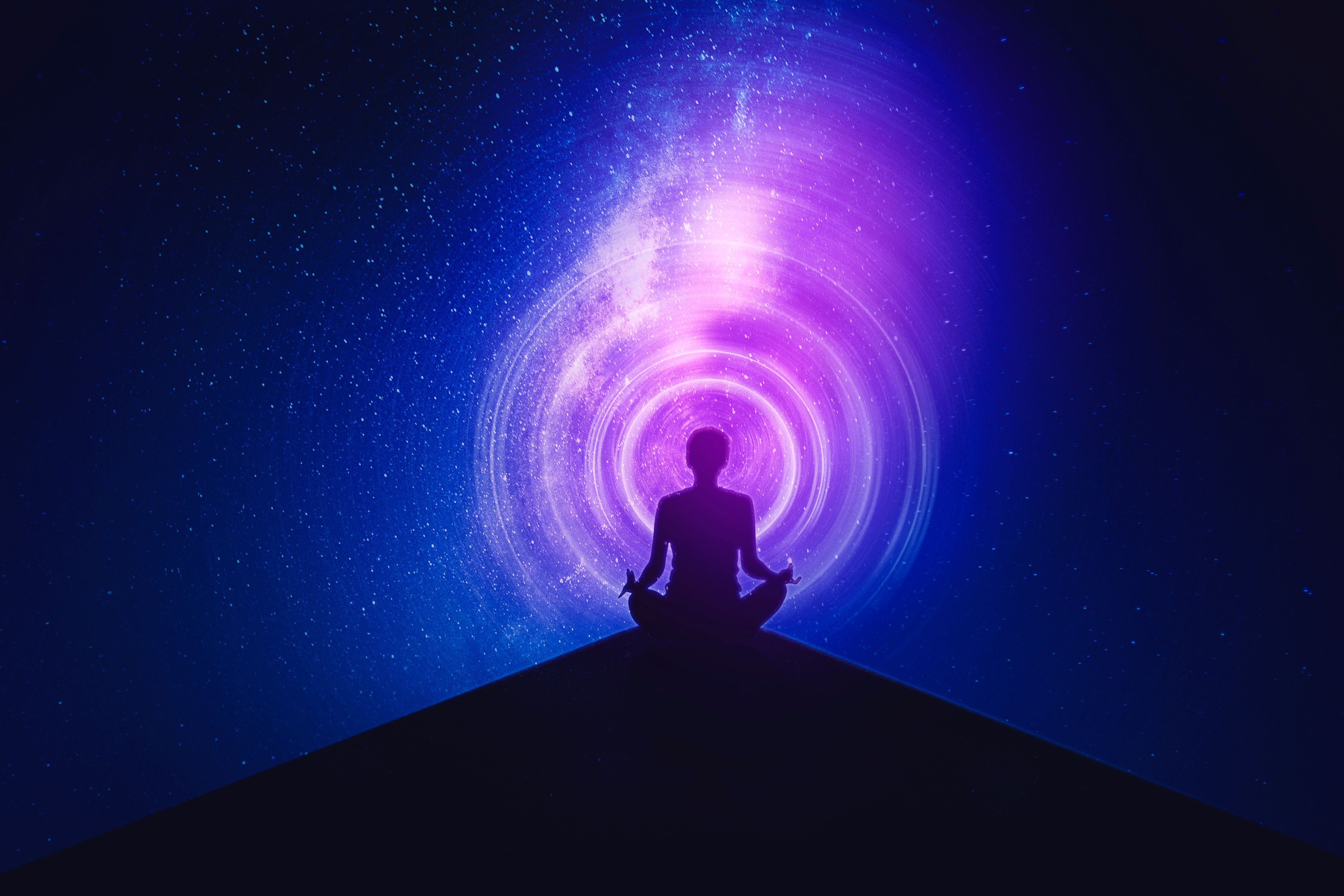Young woman meditating with milky way background