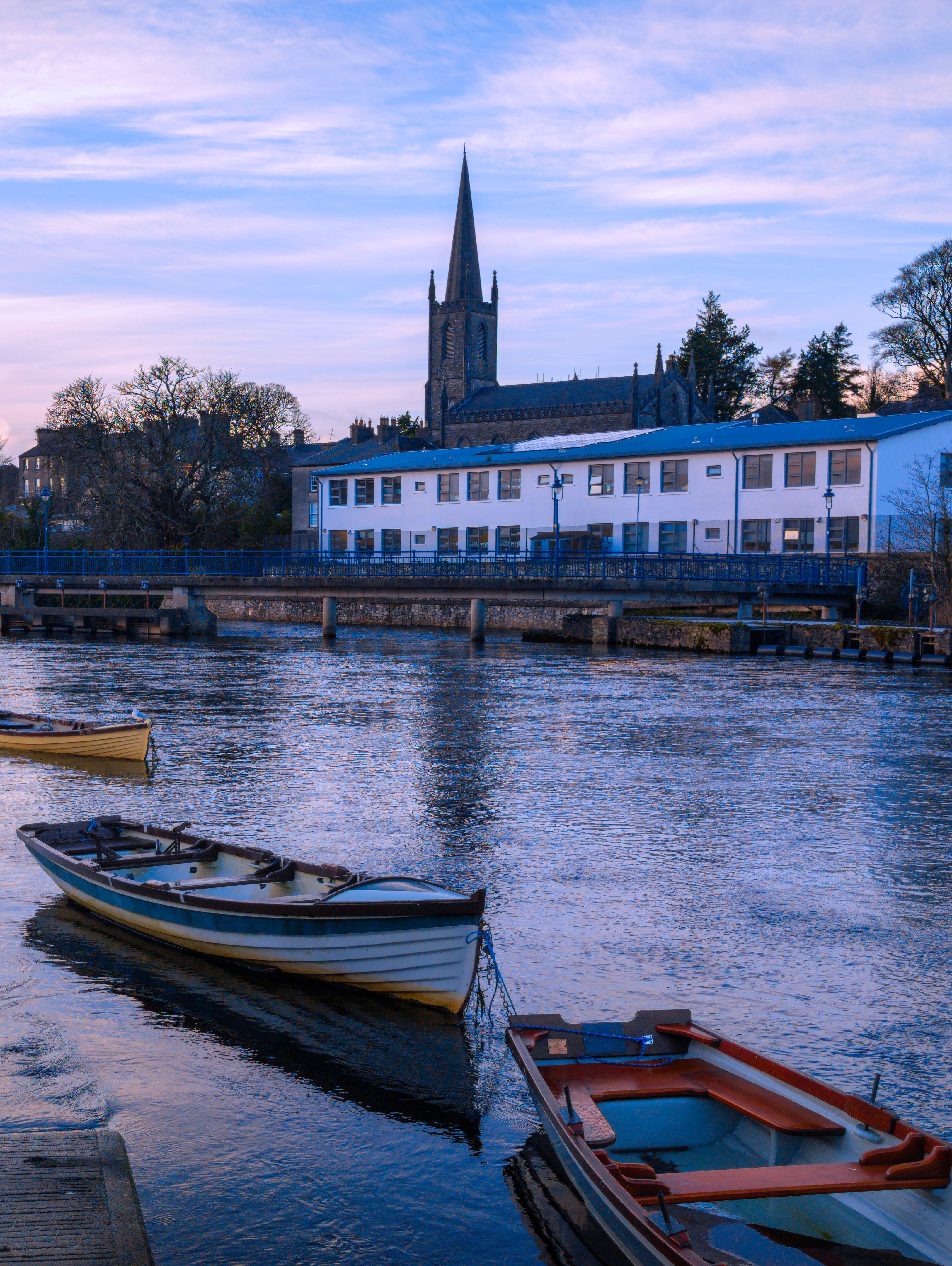 Sligo city sunset landscape with view of Calry Parish Anglican Church and moored boats over the Garavogue River