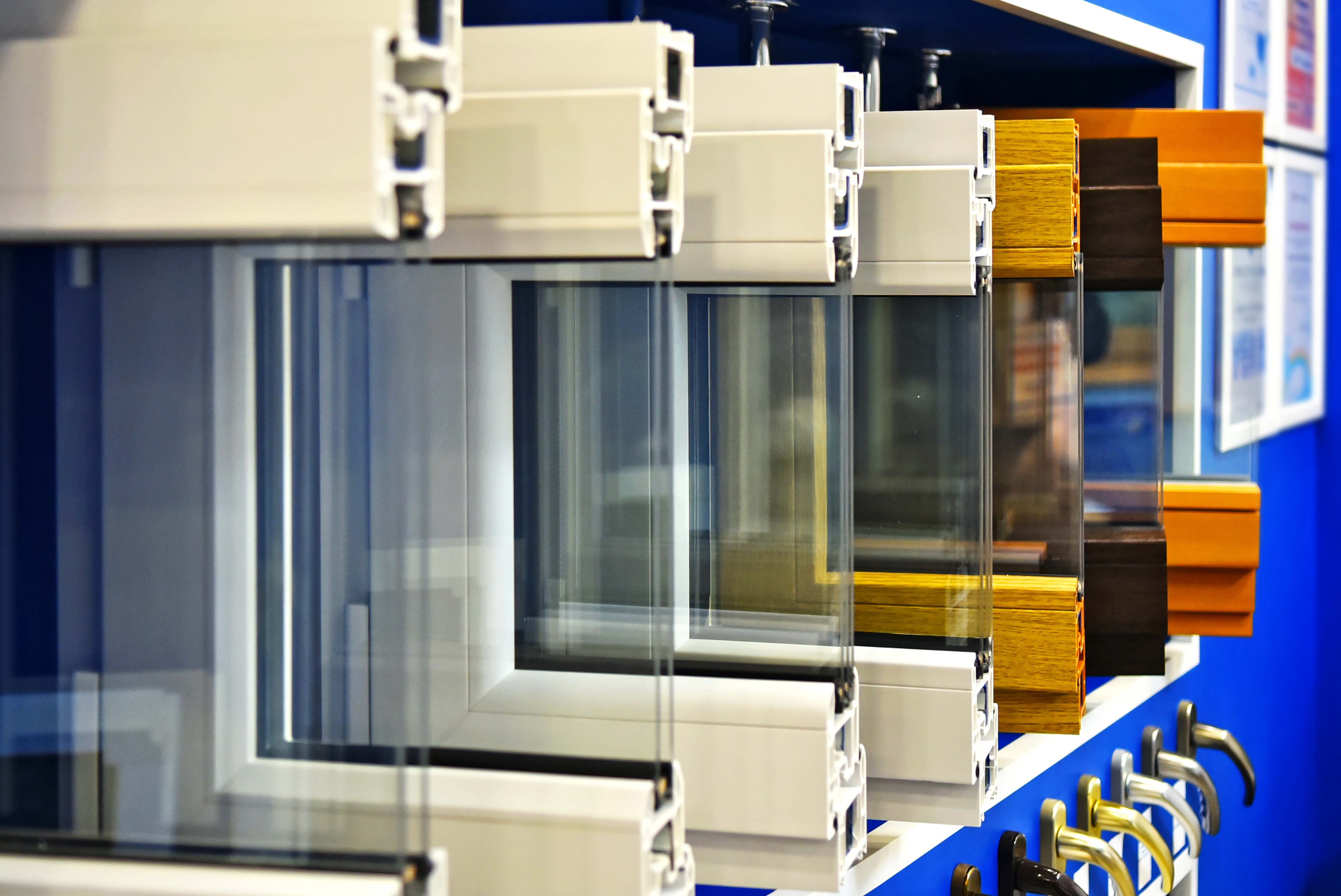 Samples of modern window profiles on a special showcase in the room. Services for the installation of Windows