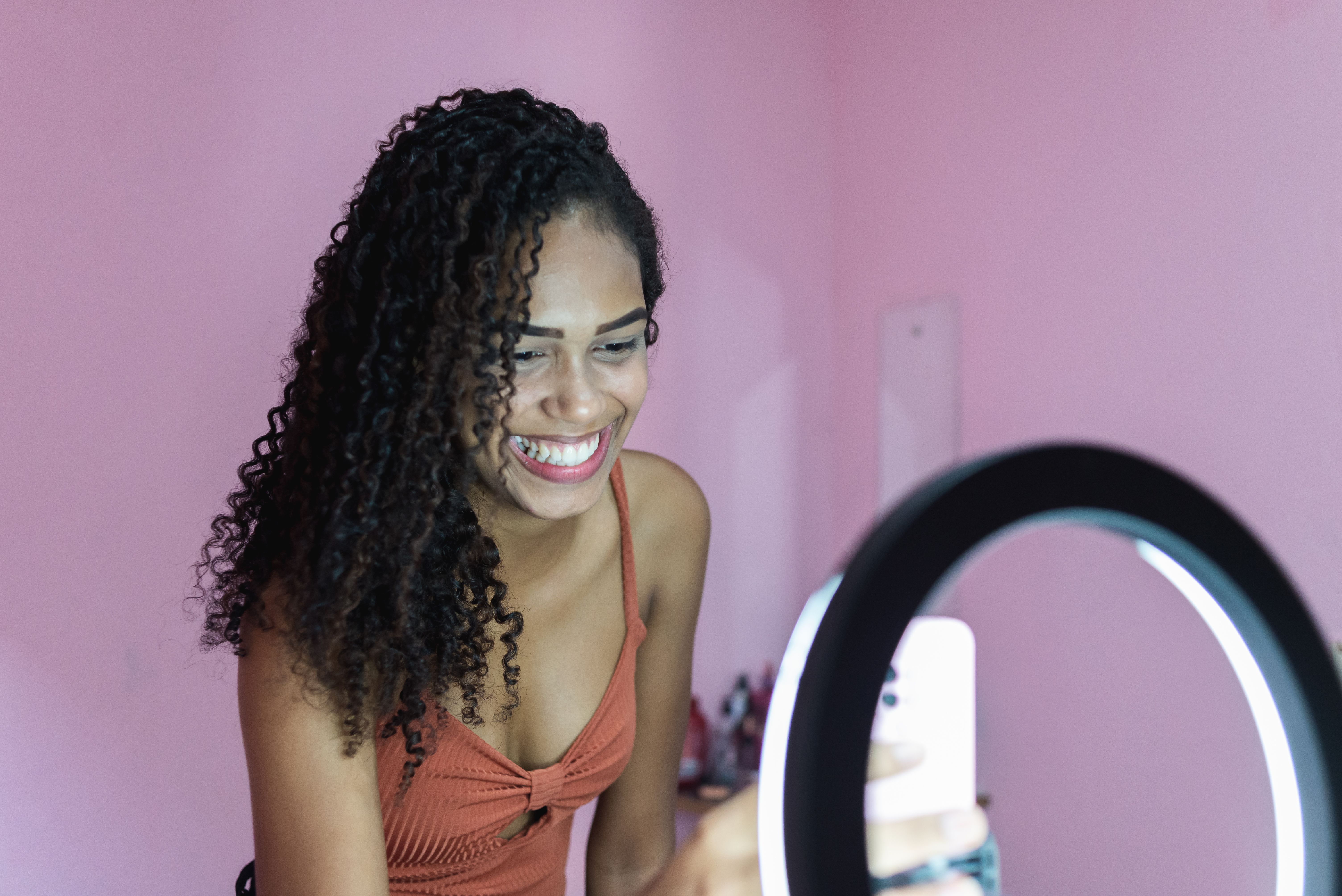 Black young woman filming herself dancing at home to share on social media Black young woman filming herself dancing at home to share on social media