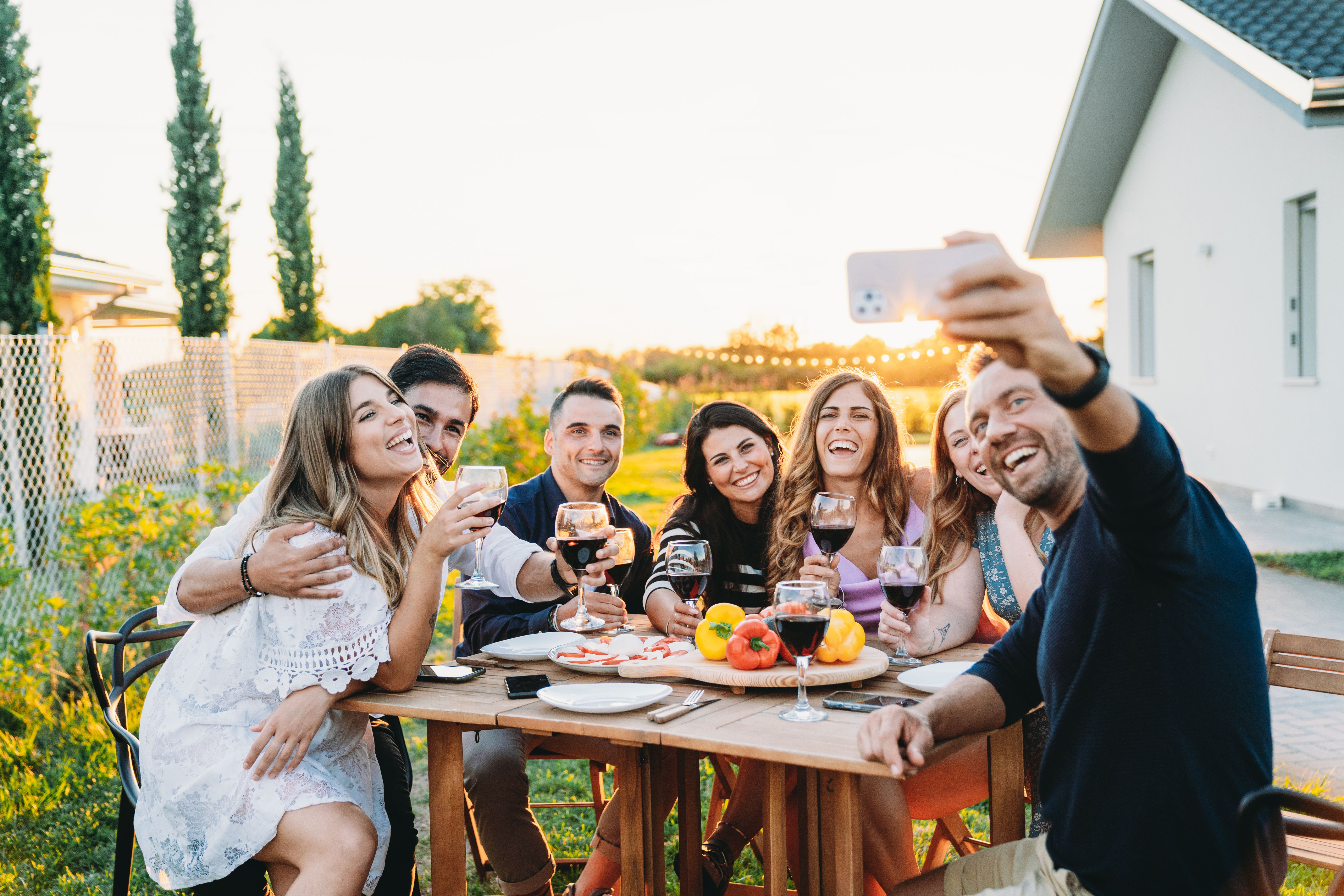 Friends are taking a selfie together during a dinner party