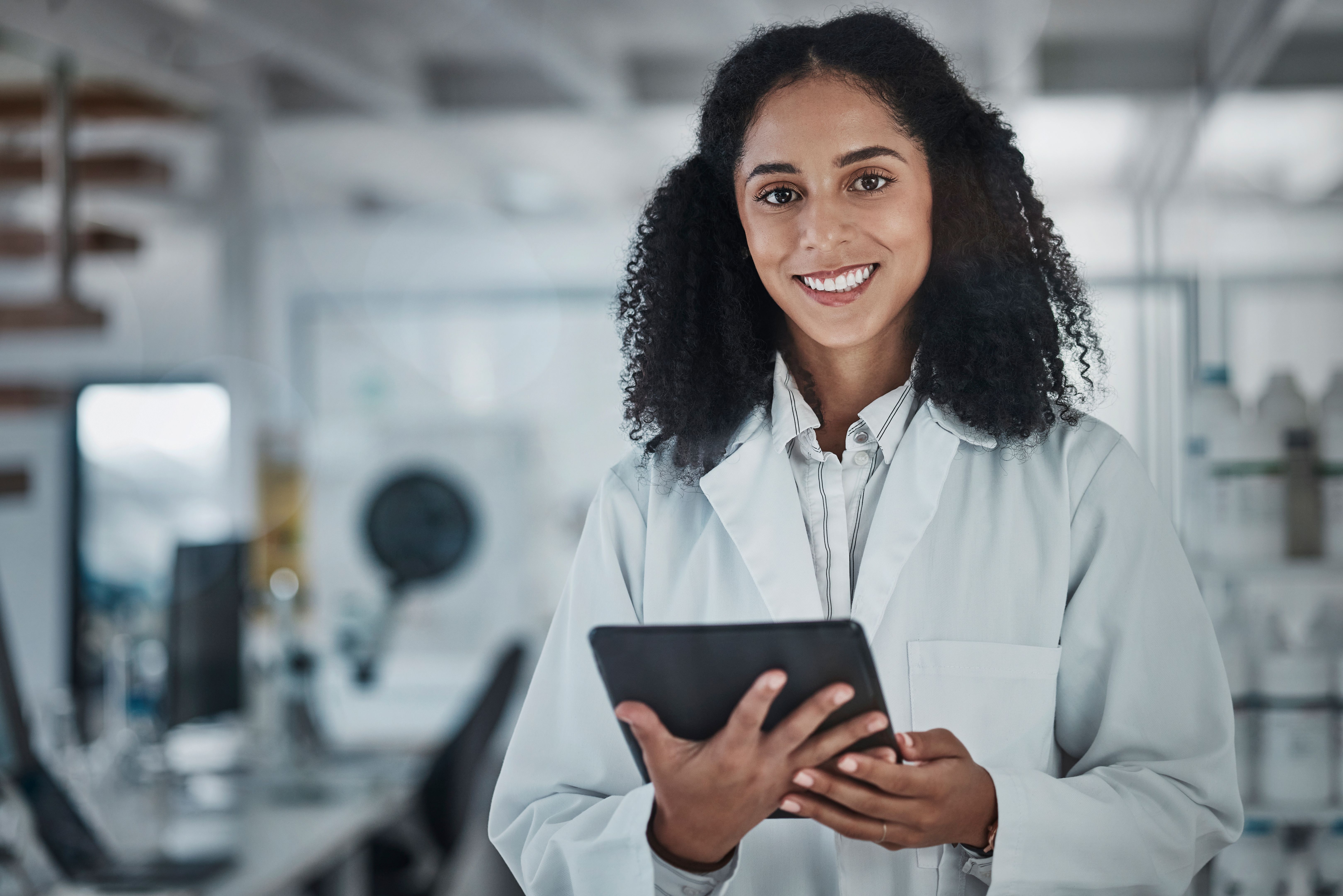 Science, research and portrait of black woman with tablet and smile in laboratory, internet and medical data search online. Healthcare, pharmaceutical innovation and happy scientist with technology