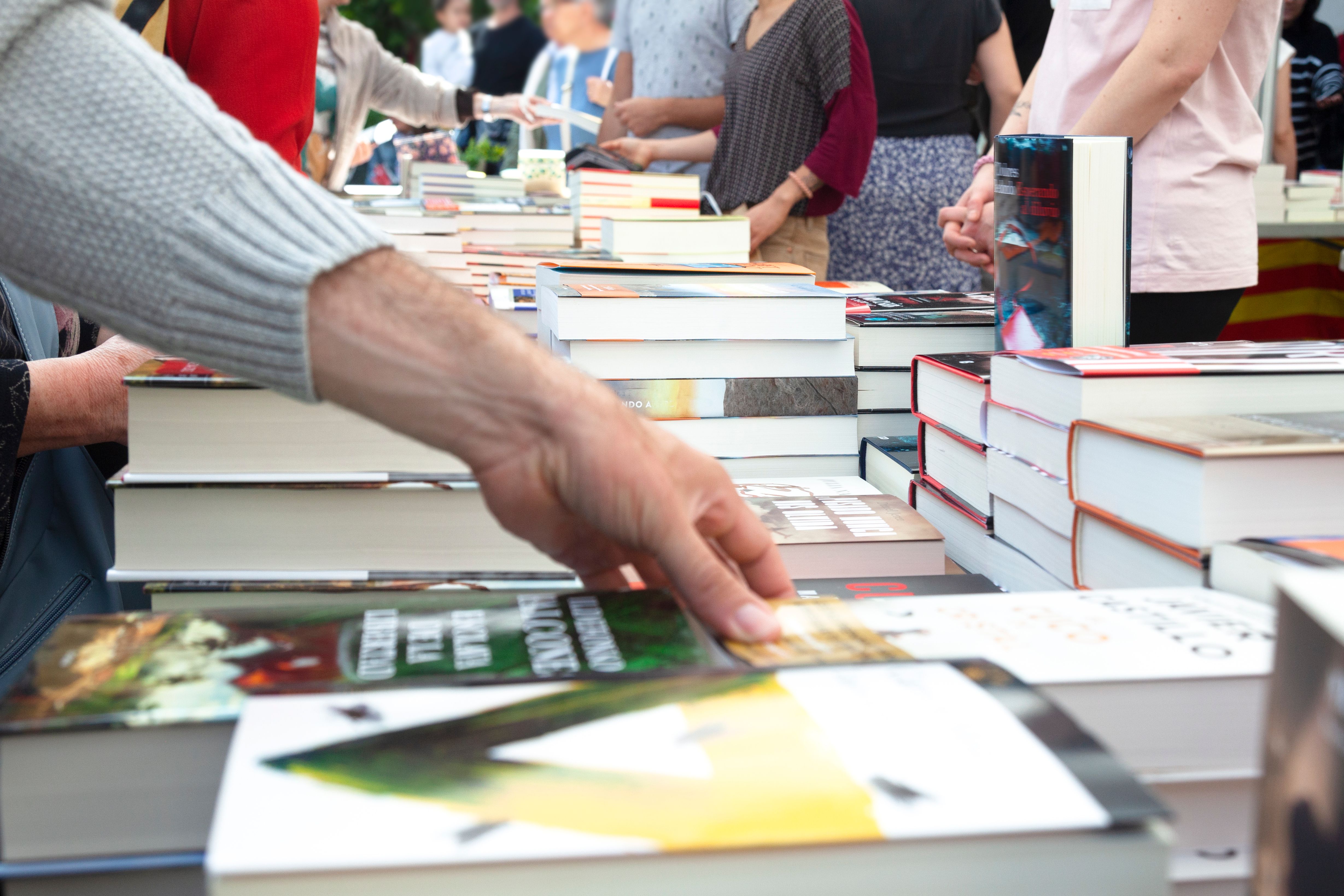 Buying books at a street stall. Buying books at a street stall.