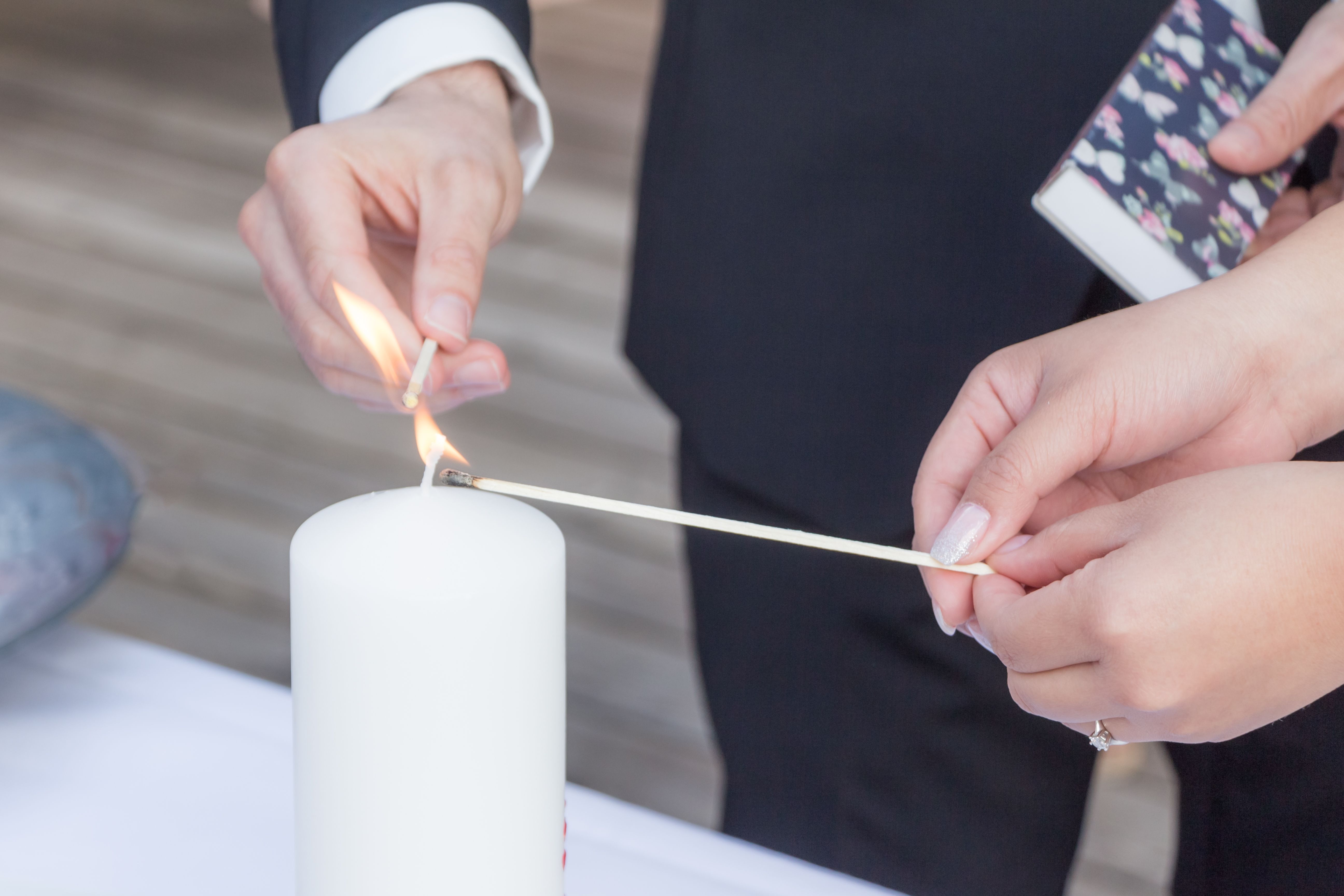 Wedding bride and groom couple burn candle at marriage ceremony