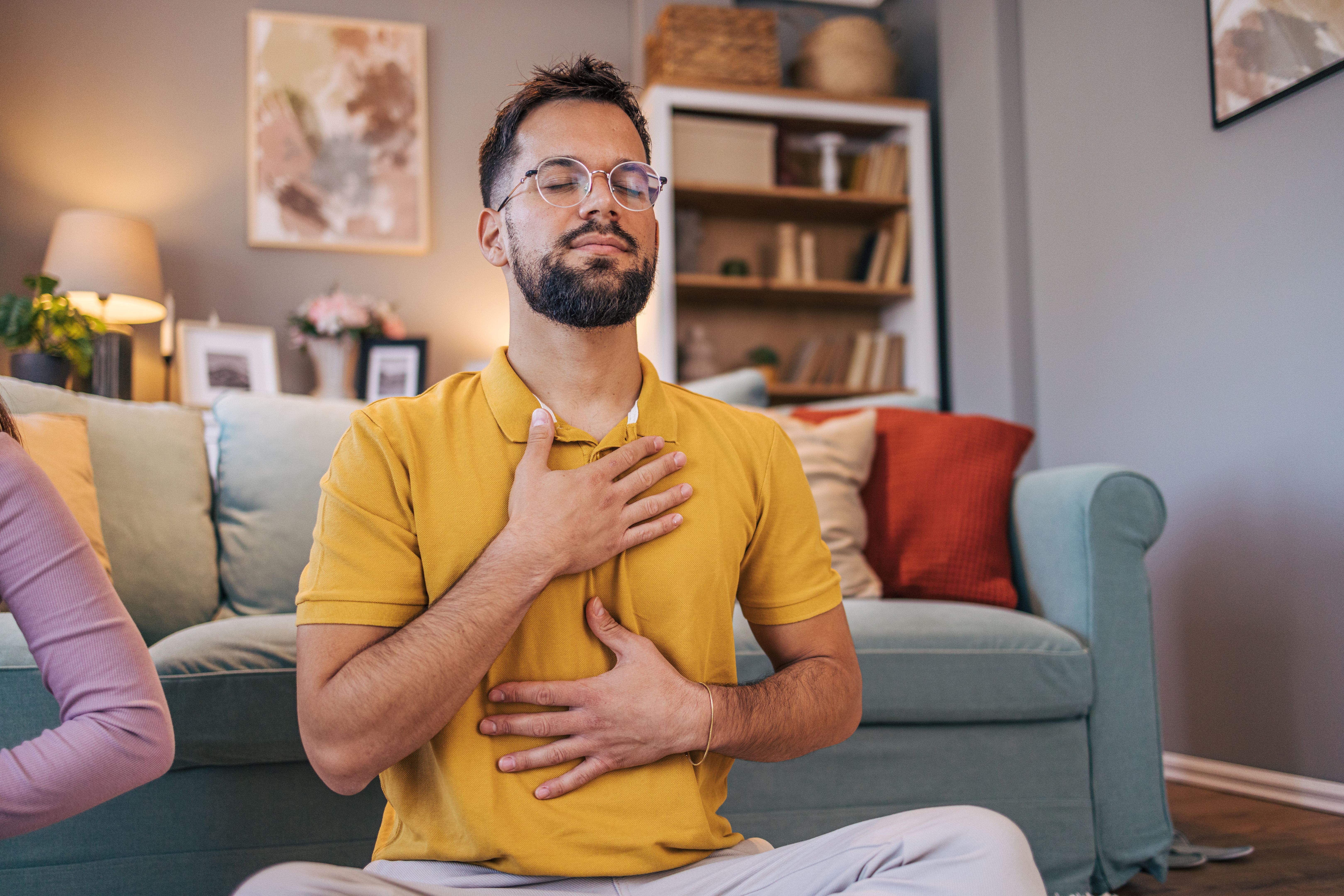 Adult couple practicing yoga at home Adult couple practicing yoga at home